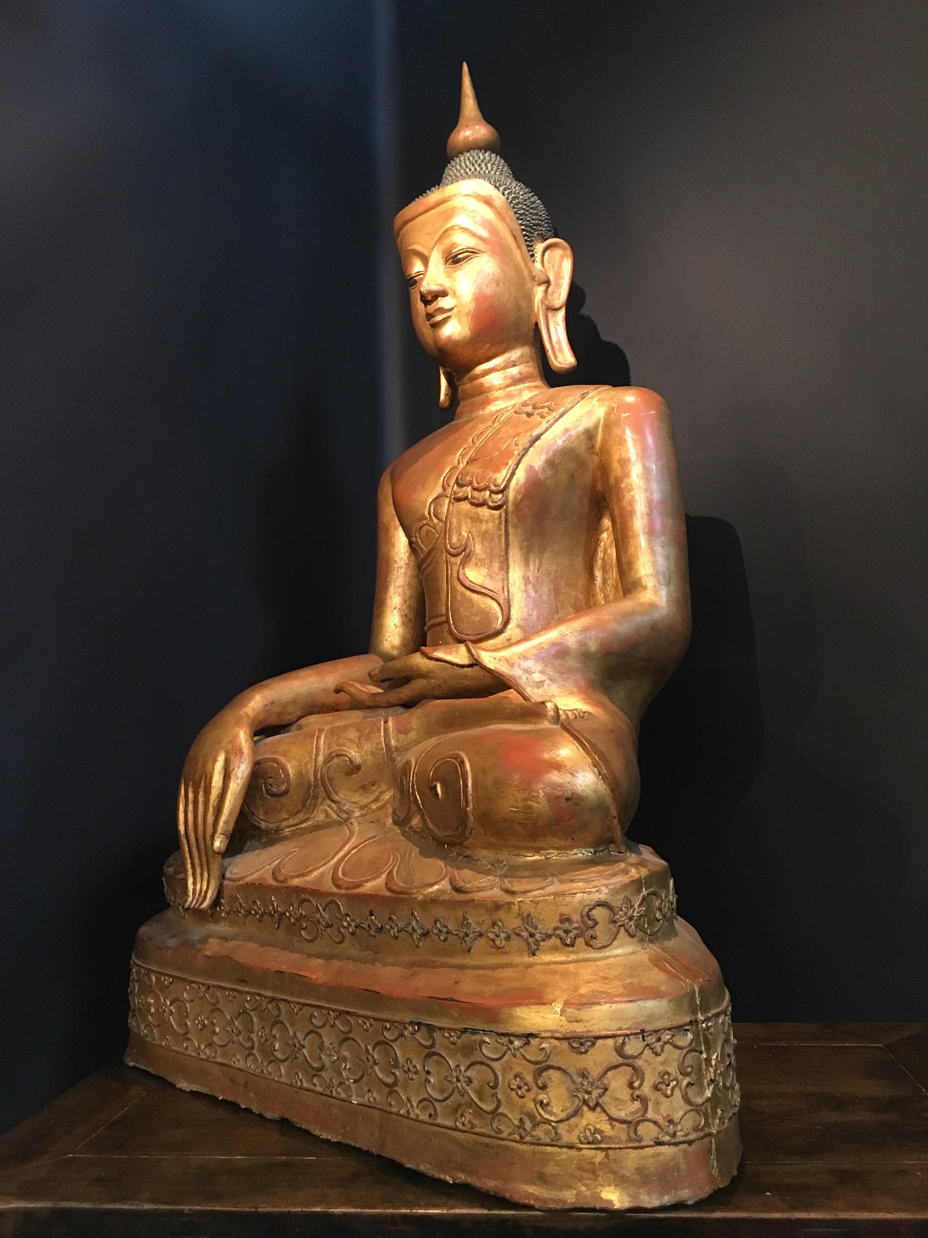 A large and impressive Burmese papier mâché gilt lacquer figure of the historical Buddha, Shakyamuni, Shan States, Burma (now Myanmar) circa 1880 - 1900.
The Buddha sits in vajrasana upon a stepped platform, hands in bhumisparsha, one hand upturned