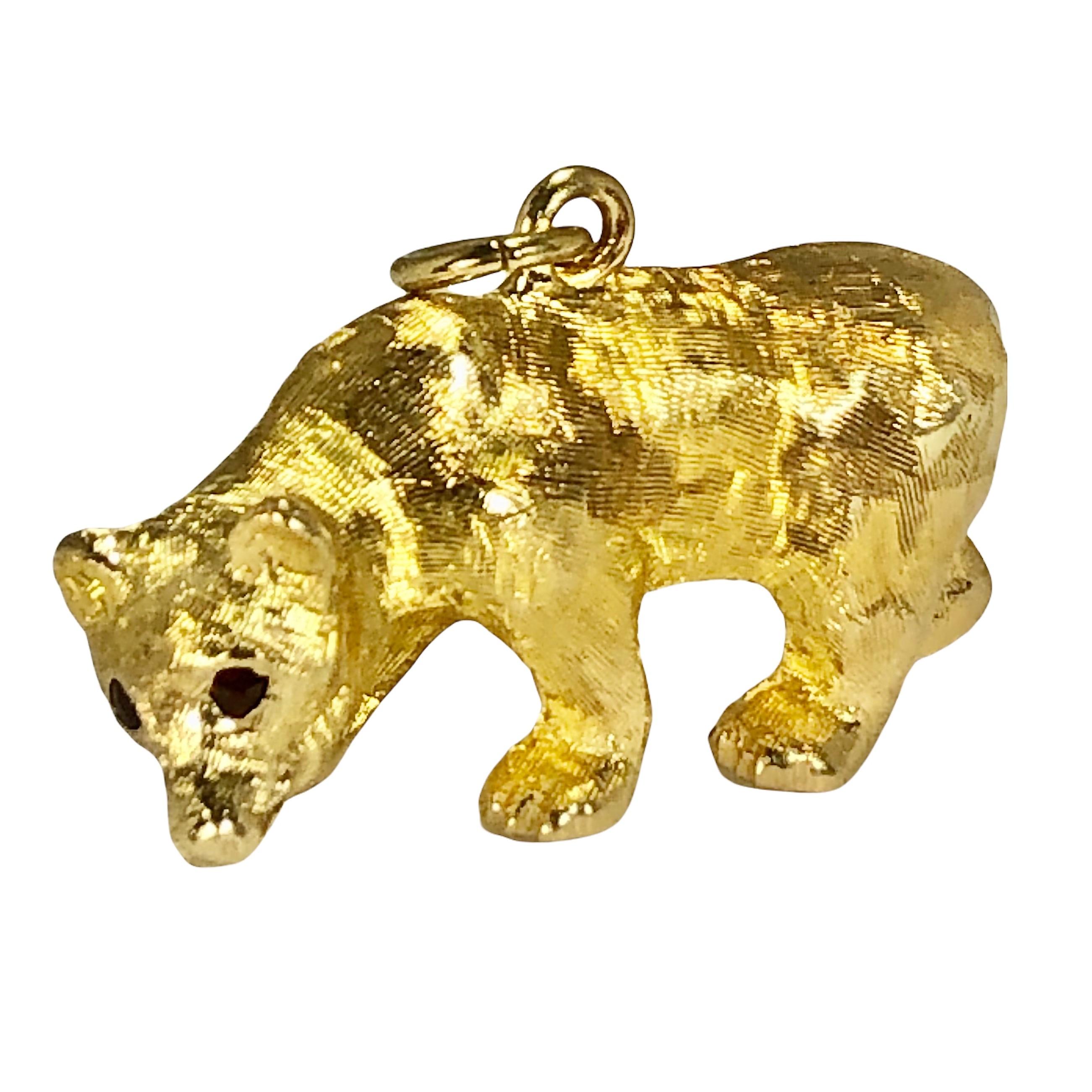 This extremely lifelike bear is fabricated from 14k gold and has a very rich 24k wash over it's entire surface. With a shimmering Florentine finish and red garnet eyes, it is truly a unique work of art. Measuring a full 1 1/2 inches in length by 3/4