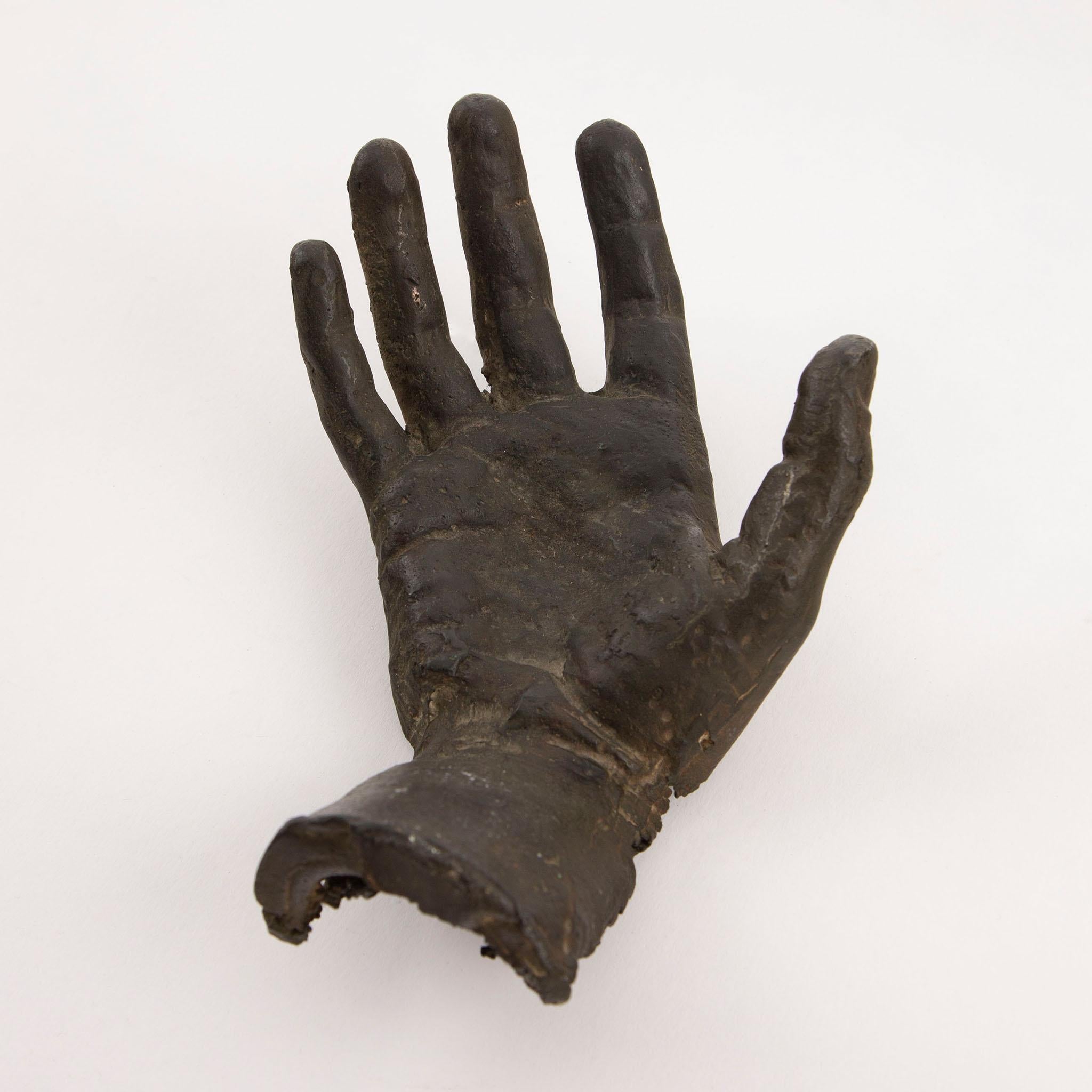 Early 20th Century Cast Bronze Right Hand — A finely detailed cast bronze sculpture of a right hand, dating to the early 1900s, capturing the naturalistic contours, lines, and lifelike proportions of the human form. The piece features a gently open