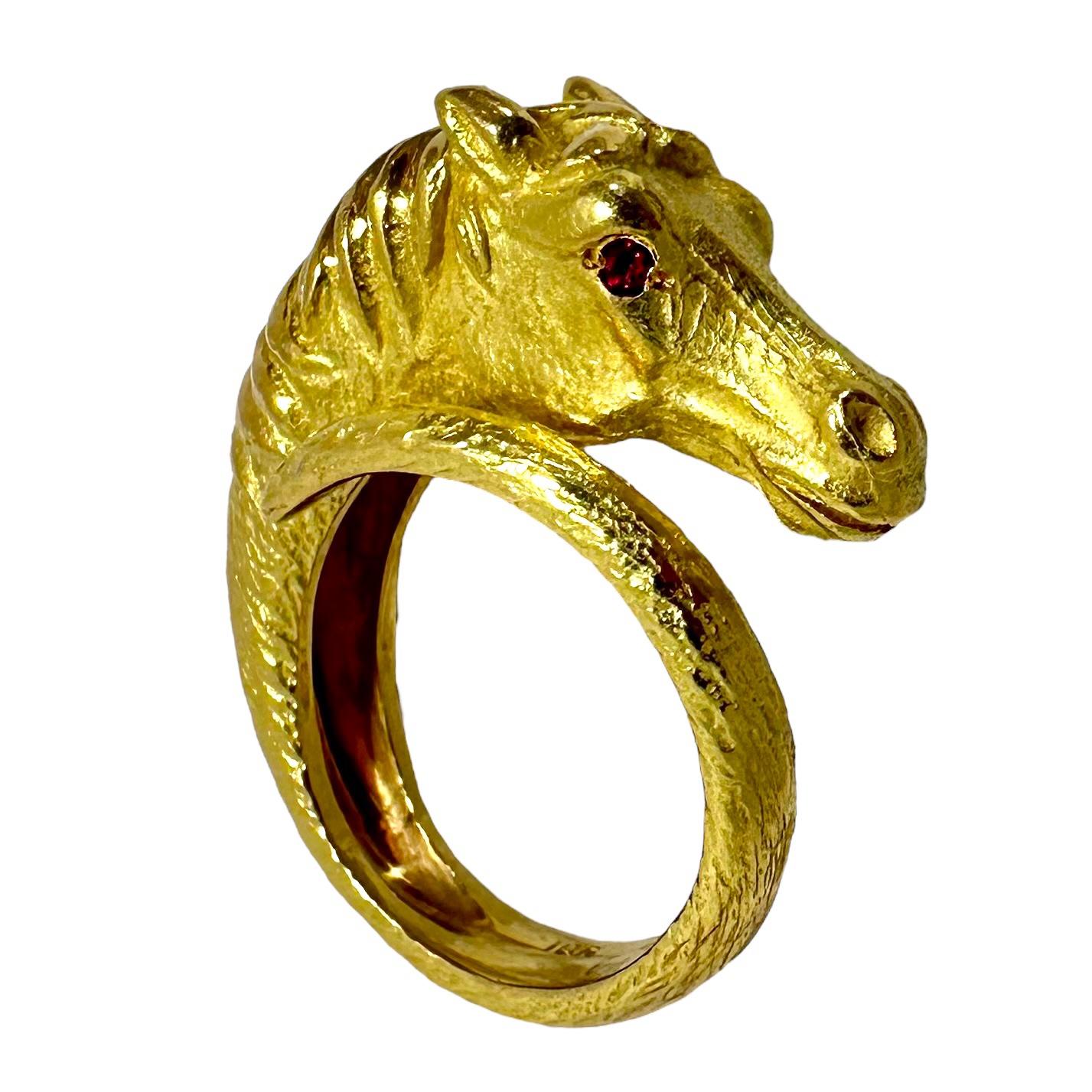 This George Lederman designer vintage horse head ring, crafted in 18k yellow gold is characteristically very well detailed. The entire surface is finished in this designers benchmark finish. The two vibrant ruby eyes complete the appearance of high