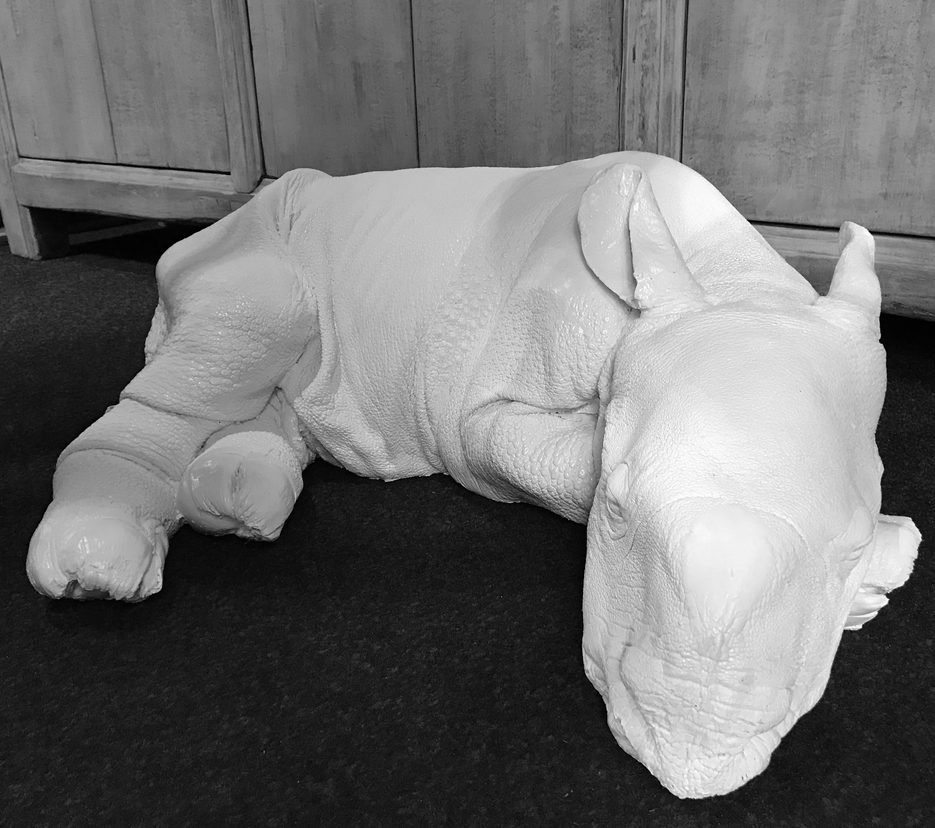Lifelike white replica of a rhino calf. The calf has all the details and can not be distinguished from real.