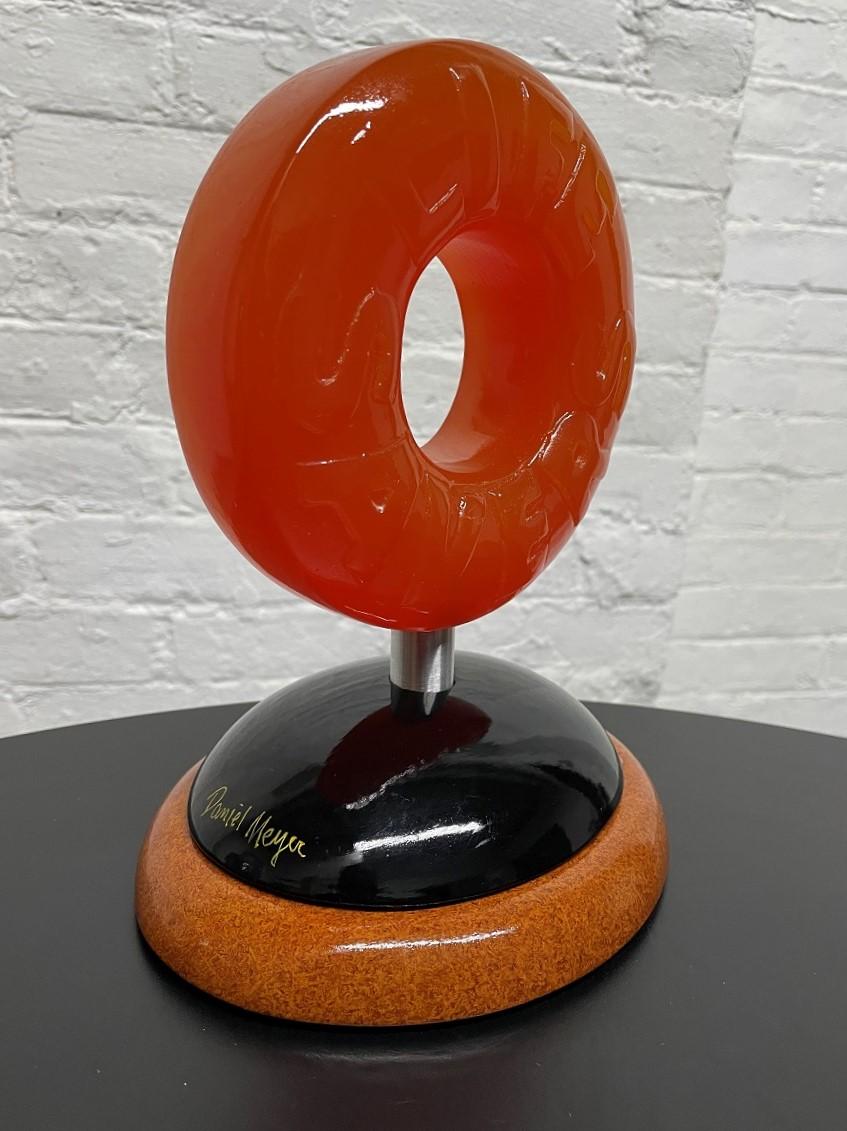 Signed, Lifesaver Candy Sculpture by Daniel Meyer. The sculpture is wood, resin and acrylic. Lifesaver is orange.