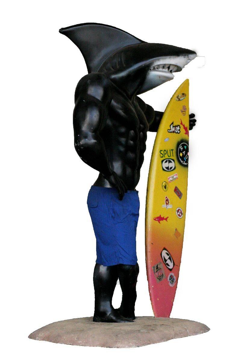 Large life-size 7.5' foot tall Maui & Sons Sharkman Mascot holding a surf board on a sandy beach base with wheels. He is made of fiberglass and is fairly heavy, the surfboard is easily detached from stand. I bought him back in the 1990s.