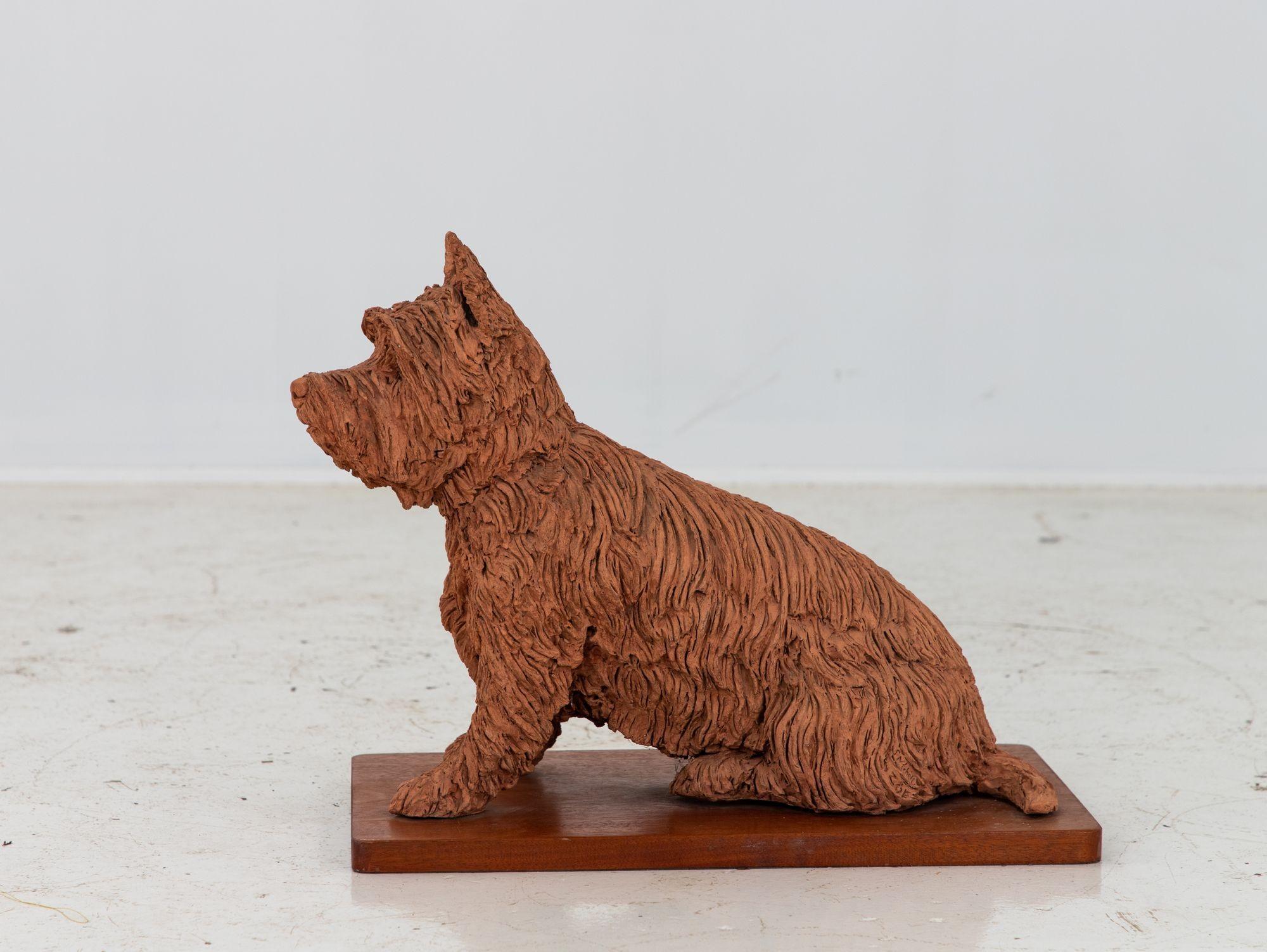 Lifesize terracotta terrier dog statue or garden ornament. English early 20th Century. Wear consistent with age and use.
