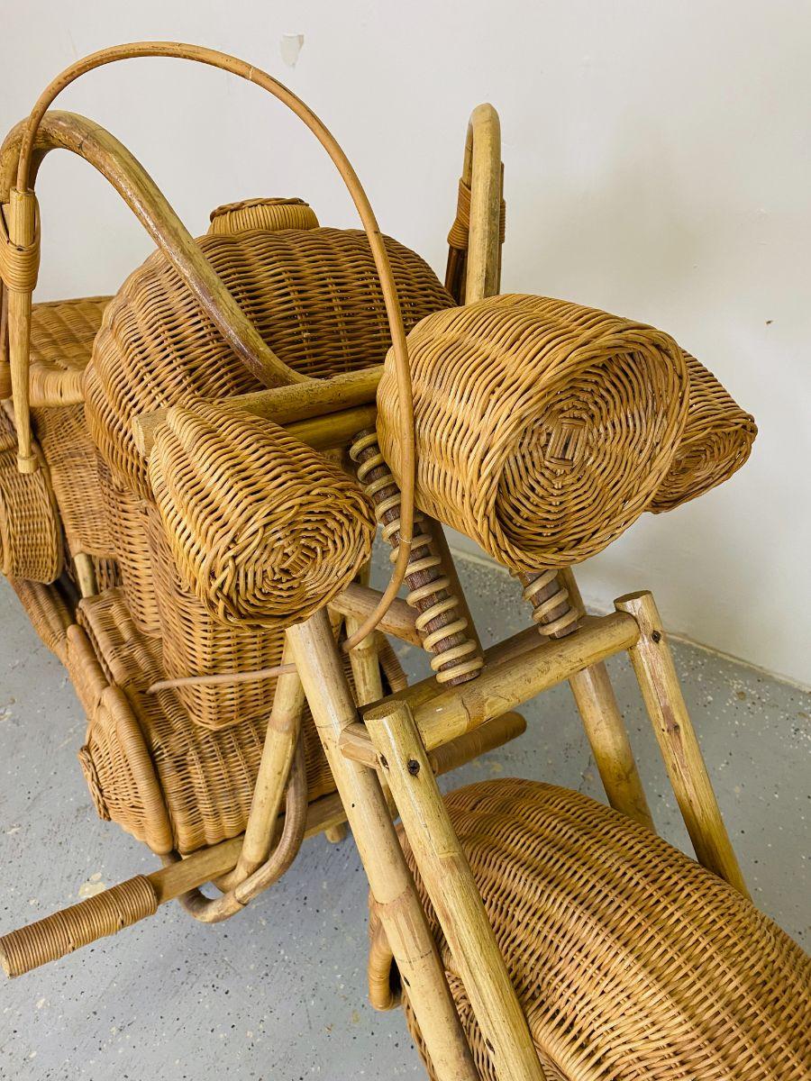 An outstanding full-size woven rattan sculpture of a motorcycle. Although I am unsure of the origin these have been attributed to Tom Dixon stores in the late 80s. Shows age but loos great overall.
      