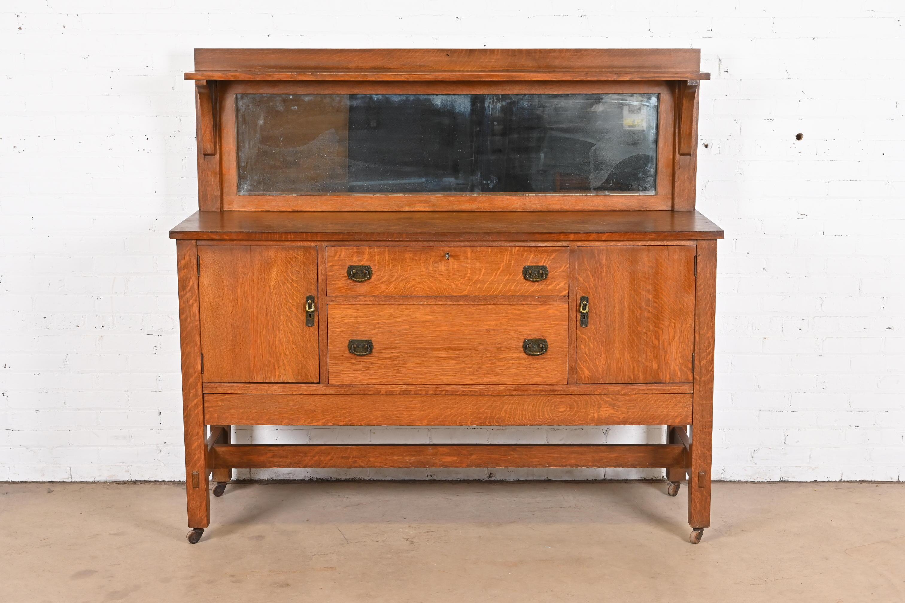 A gorgeous antique Mission or Arts & Crafts sideboard, buffet server, or bar cabinet

By Lifetime Furniture

USA, Circa 1900

Quarter sawn oak, with mirrored backsplash, and original hammered copper hardware.

Measures: 66