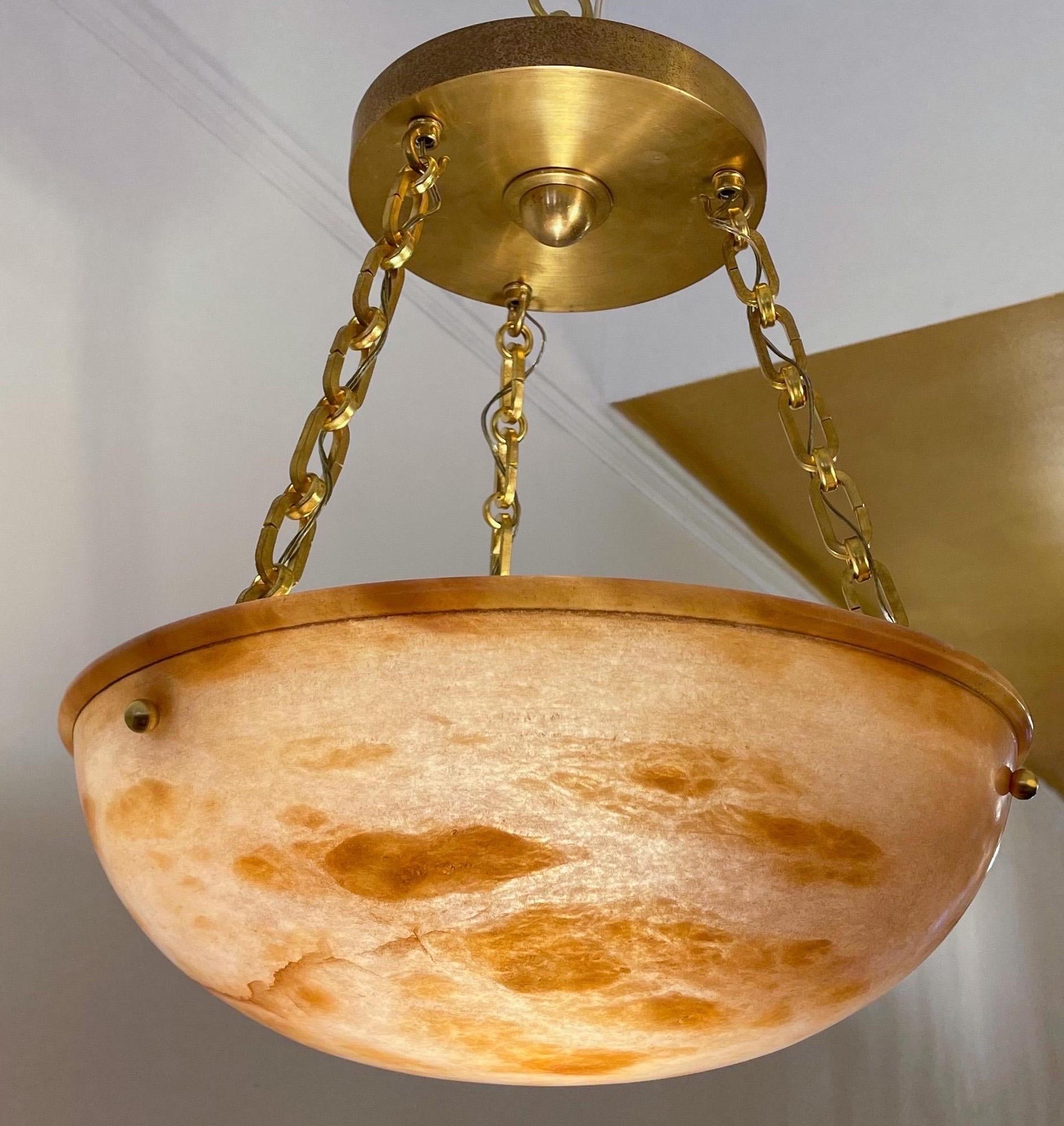 This one is peachy-keen! When you need a subtle bit of color, this elegant pendant is perfect! Newly rewired on chains with a matching brass canopy, the light can be rewired again to your custom overall drop with rods or electrified roping in our