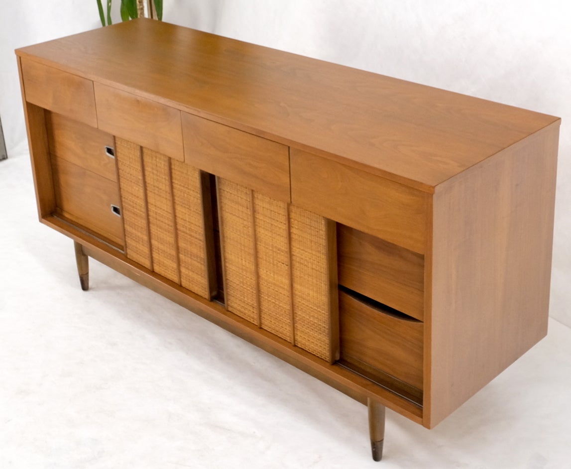 Light American walnut multi drawer sliding cane doors dowel leg long credenza dresser.
Amazing vintage cosmetic condition with wonderful original amber tone finish. All in perfect operation condition.