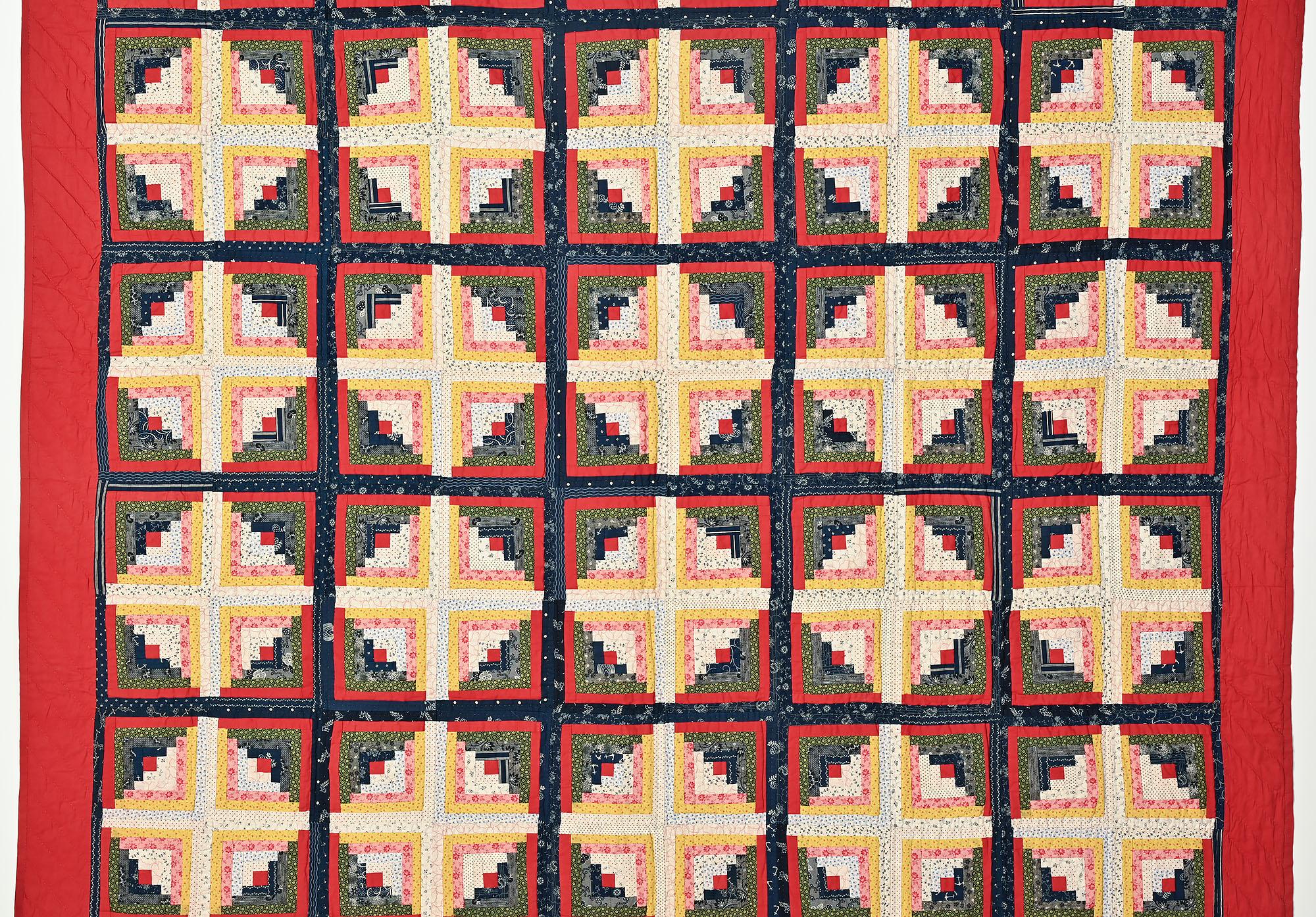 This Light and Dark Log Cabin quilt has more depth than the usual version of this pattern. The blocks are outlined with both red and indigo creating a frame around each of the diamond shape blocks. The placement of fabrics gives this quilt a nice
