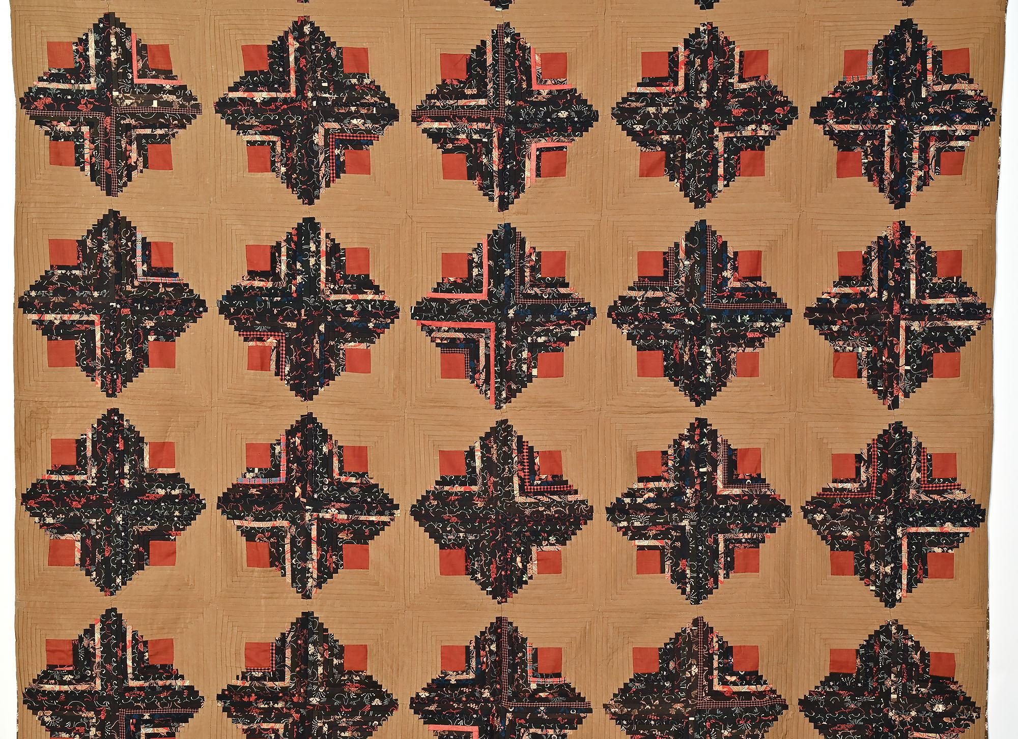Light and Dark Log Cabin quilt done in a combination of solid and printed wool fabrics. The cafe au lait colored background is an unusual tone and works perfectly with the persimmon color solid squares and darker prints. The printed fabrics echo the