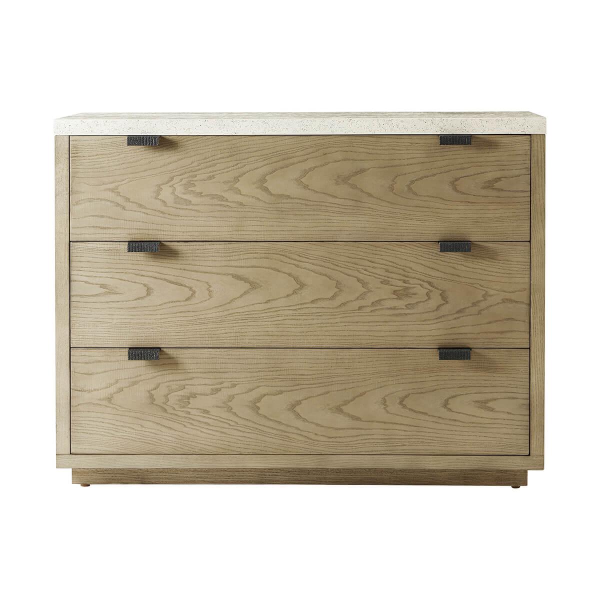 Made of figured cathedral ash in an artful grain pattern with soft close drawers. Finished in a light dune color with metal pulls in an Ember color. The top is done in an exclusive porous Mineral finish.

Dimensions: 50