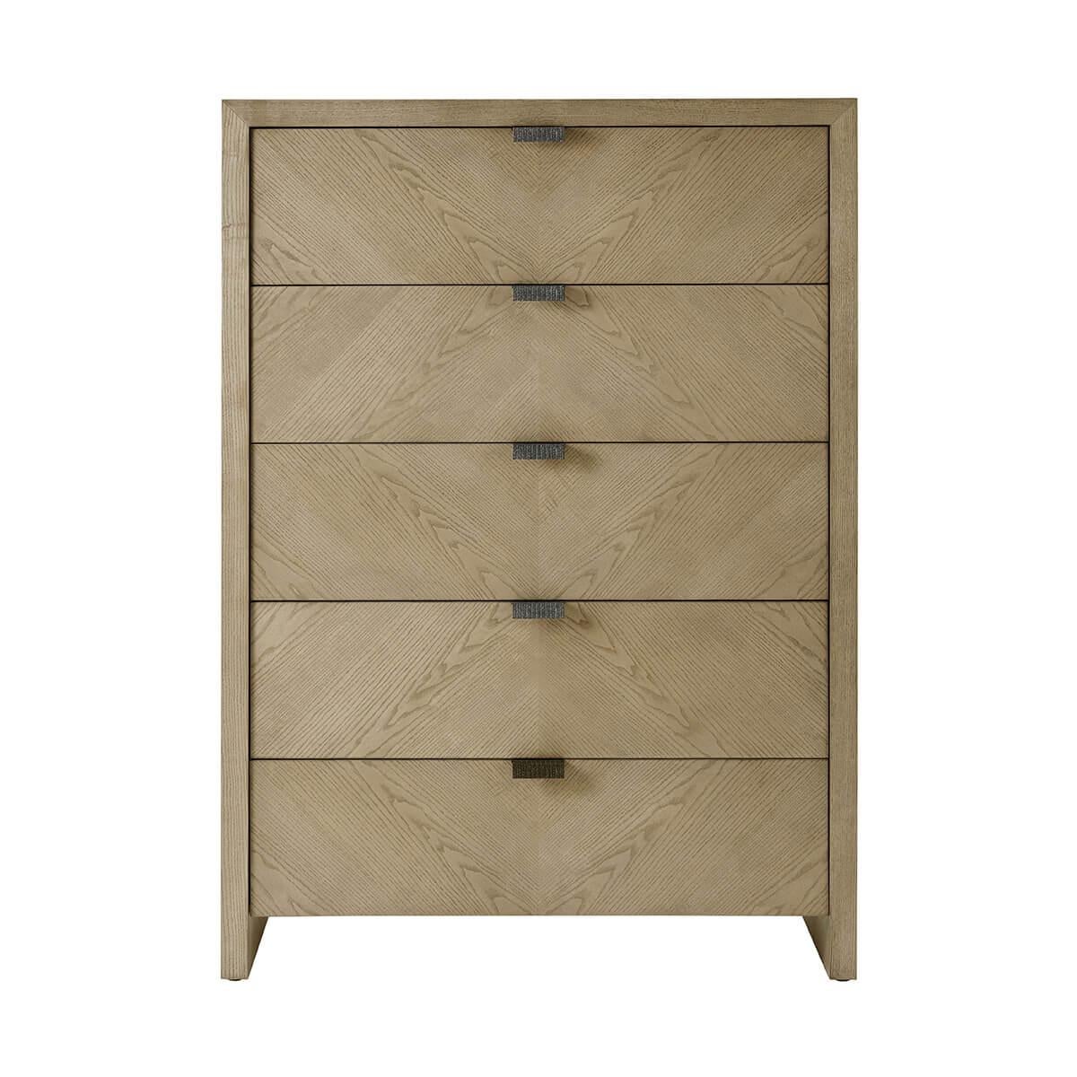 A handsome five-drawer tall bedroom chest made of figured ash in light Dune finish with textured metal pulls in our Ember finish and soft close drawers.

Dimensions: 40