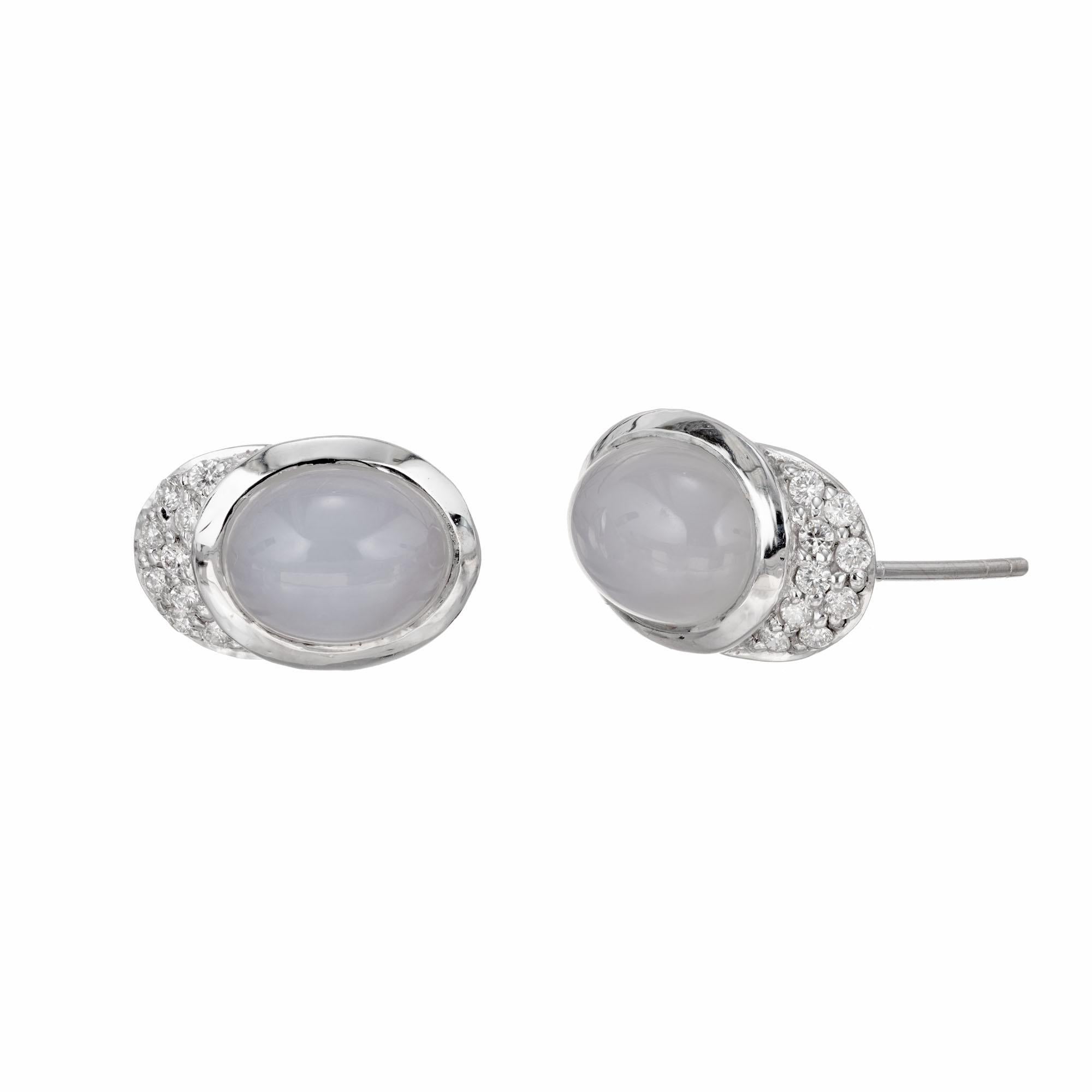Translucent blue oval cabochon Chalcedony and diamond earrings in 18k white gold.

2 natural cabochon translucent blue Chalcedony, approx. total weight 4.00cts, 10 x 8mm
18 round full cut diamonds, approx. total weight .28cts, F to G, VS
Stamped