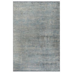 Alfombra azul claro y gris plateado de rejilla ajustada con motivos geográficos abstractos y brillo