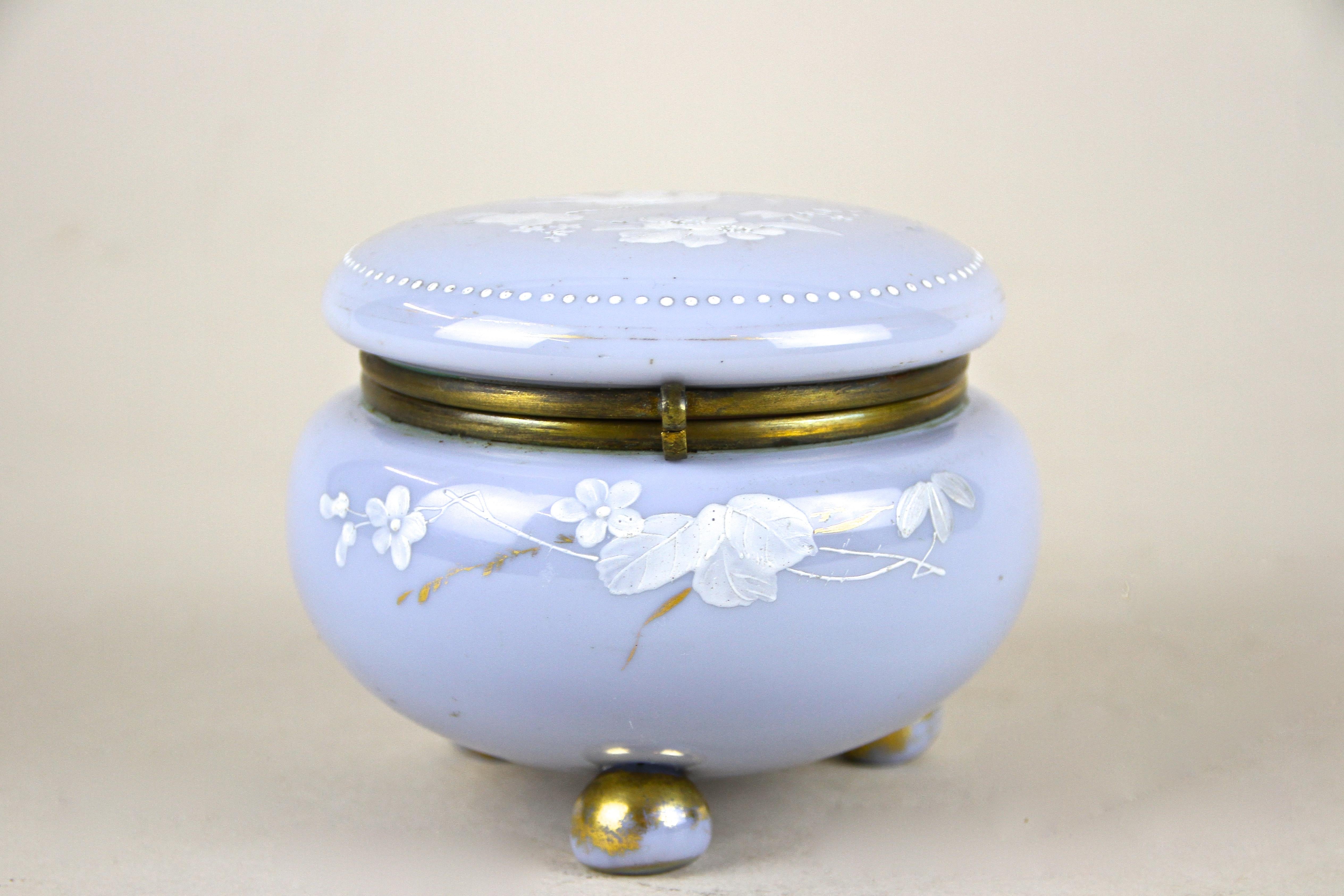 Enchanting light blue glass box adorned by lovely hand painted enamel paintings from the early period around 1900 in Austria. An absolute lovely piece of glass art impressing with wonderful enamel painted flowers and a bird on top of the lid. An