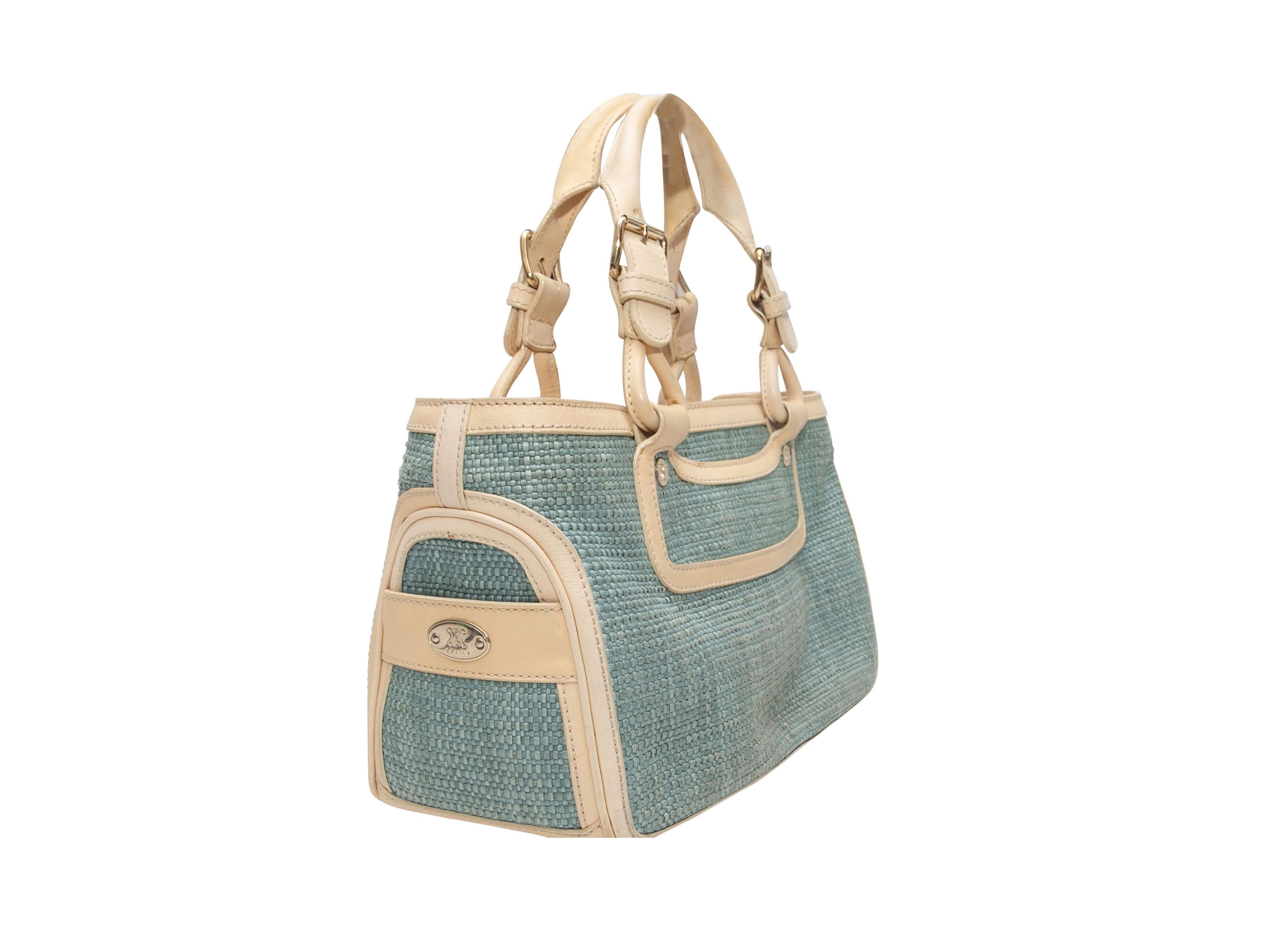 Light Blue & Beige Celine Boogie Handbag. The Boogie Handbag features a woven straw and leather body, light gold-tone hardware, dual rolled top handles, and a top zip closure. 12.5