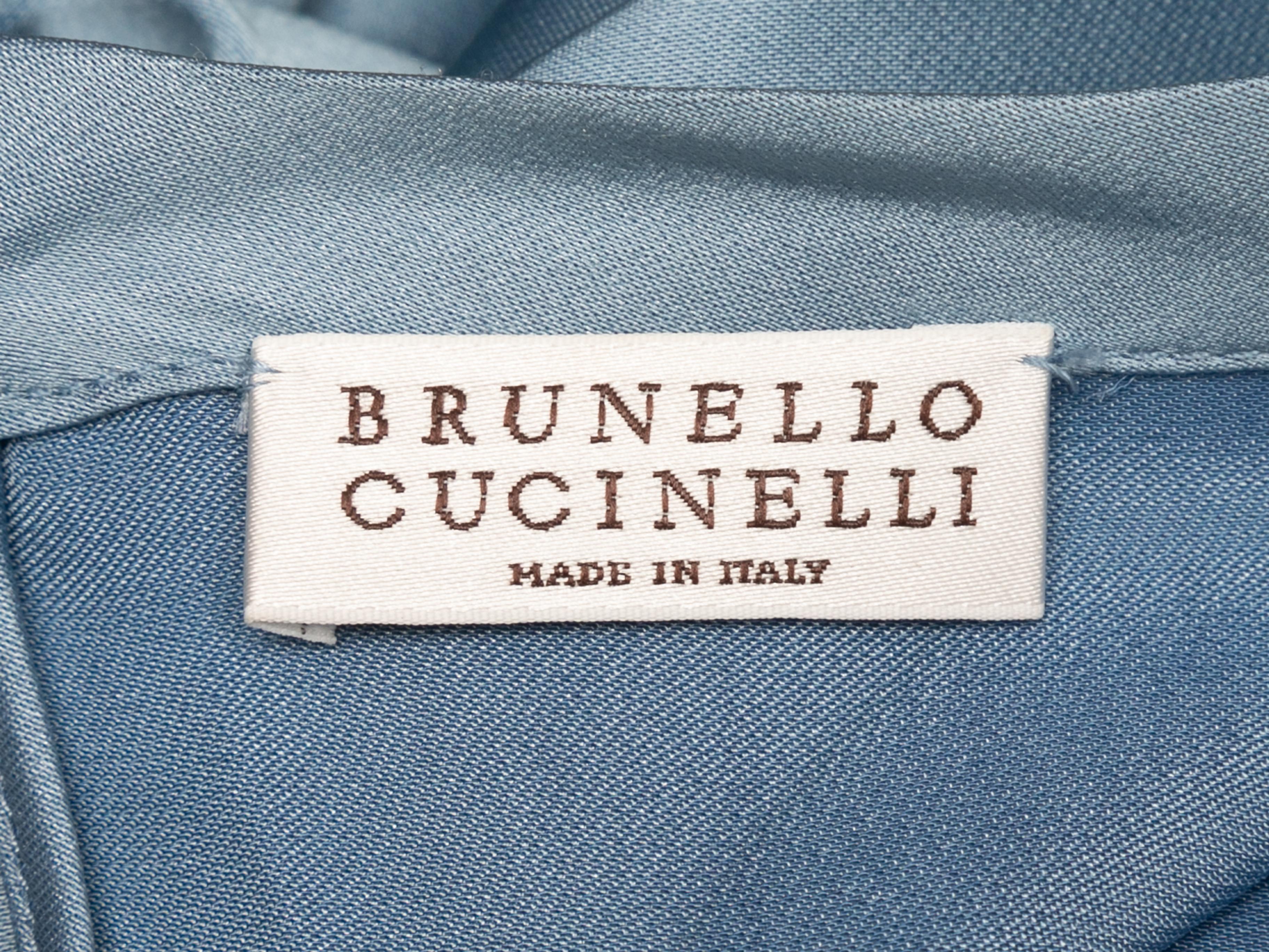 Light blue satin long sleeve blouse by Brunello Cucinelli. Grosgrain and Monili trim at sleeves. Crew neck. Button closure at nape. 30