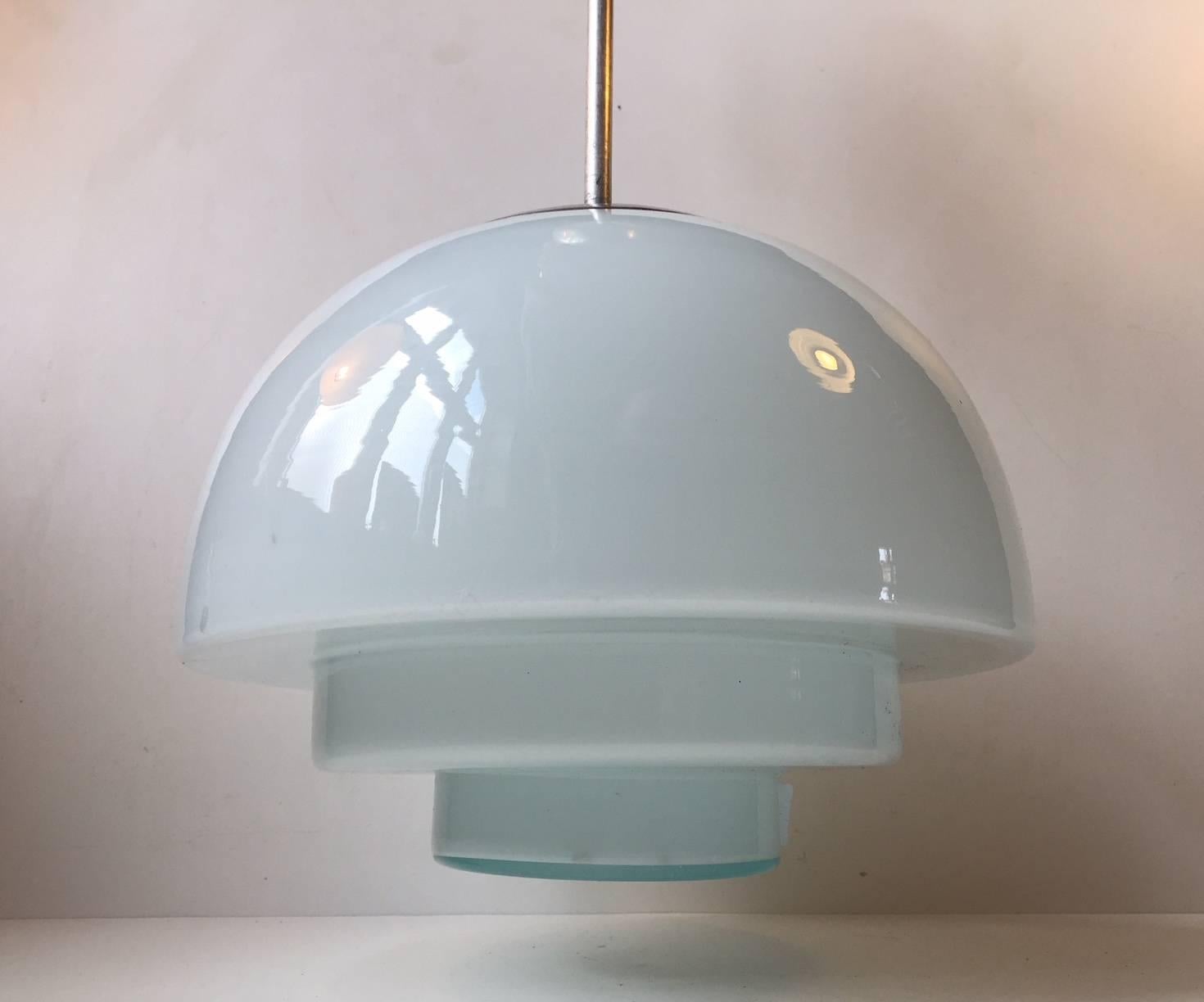 This Scandinavian Art Deco ceiling light was produced in the late 1930s or early 1940s in the style reminiscent of Peter Behrens, Otto Müller and Louis Poulsen. The opaline glass shade is fitted with its original stem, canopy, and mount in