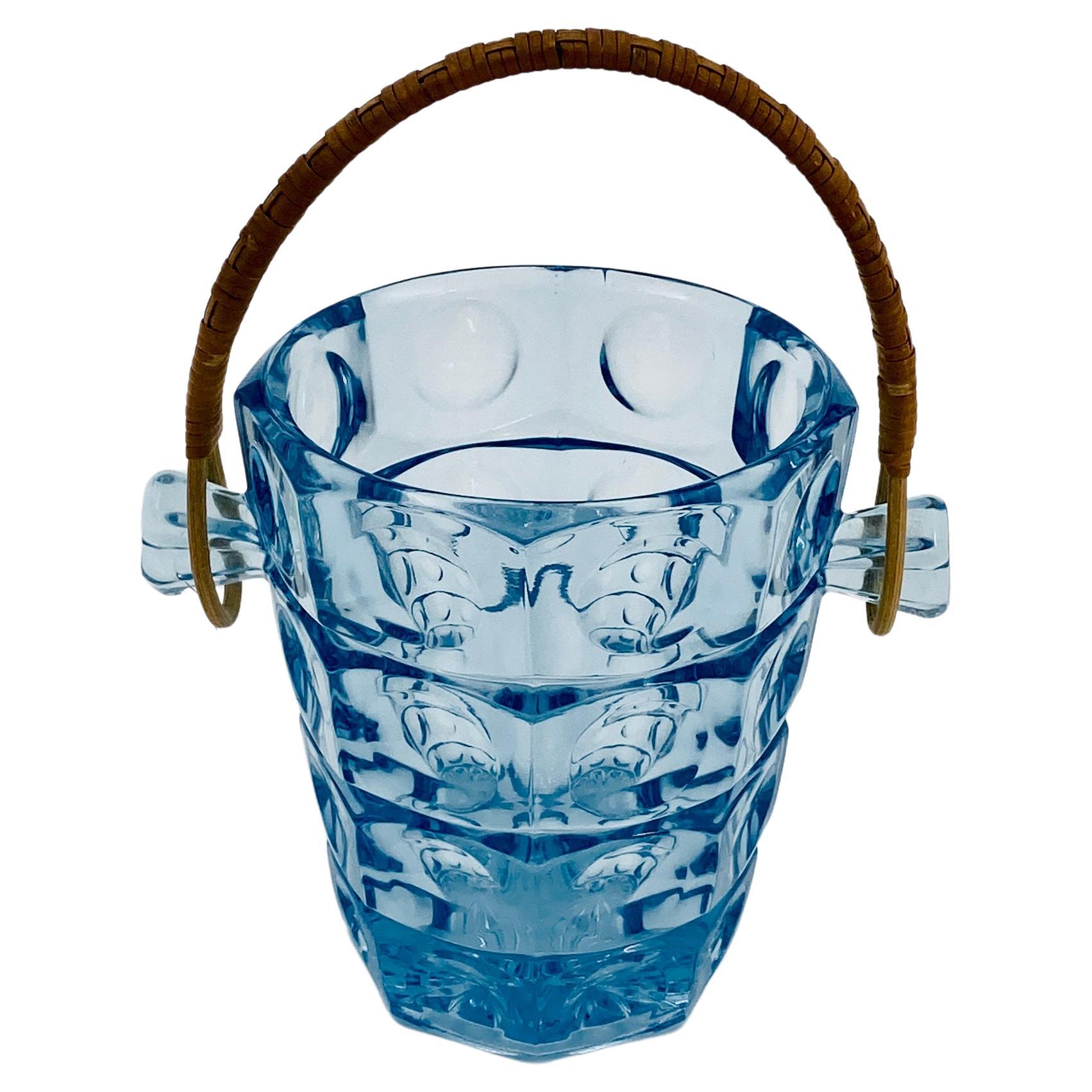 Scandinavian Mid-Century Modern Ice Bucket in Light Blue Glass and Rattan Handle. Designed by Jacob Bang for Holmegaard in the late 1950's.
Made in Denmark.

 
