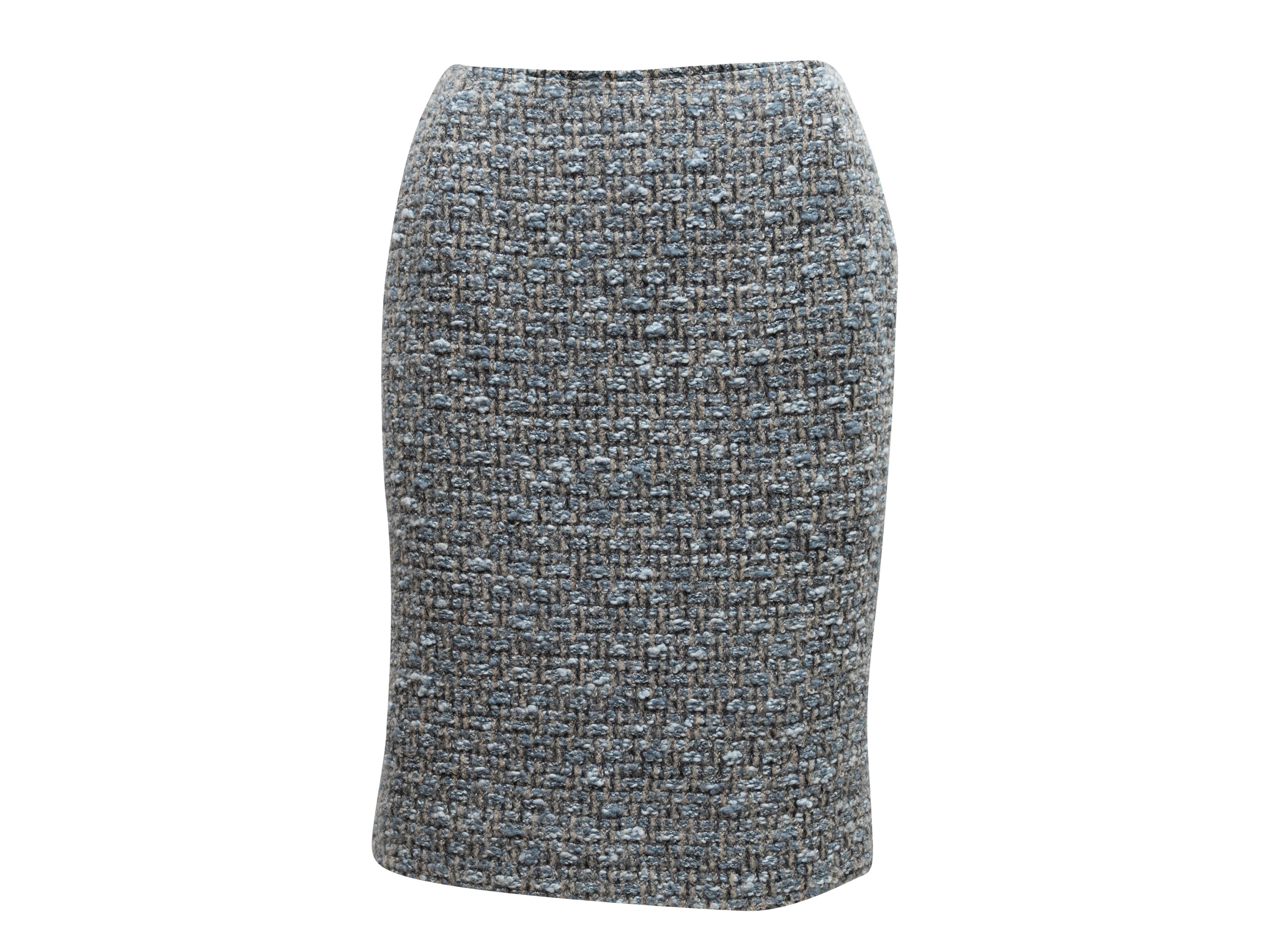Light blue and grey wool and cashmere tweed skirt suit by Oscar de la Renta. Jacket features fringe trim and front zip closure. Skirt features zip closure. Jacket- 36