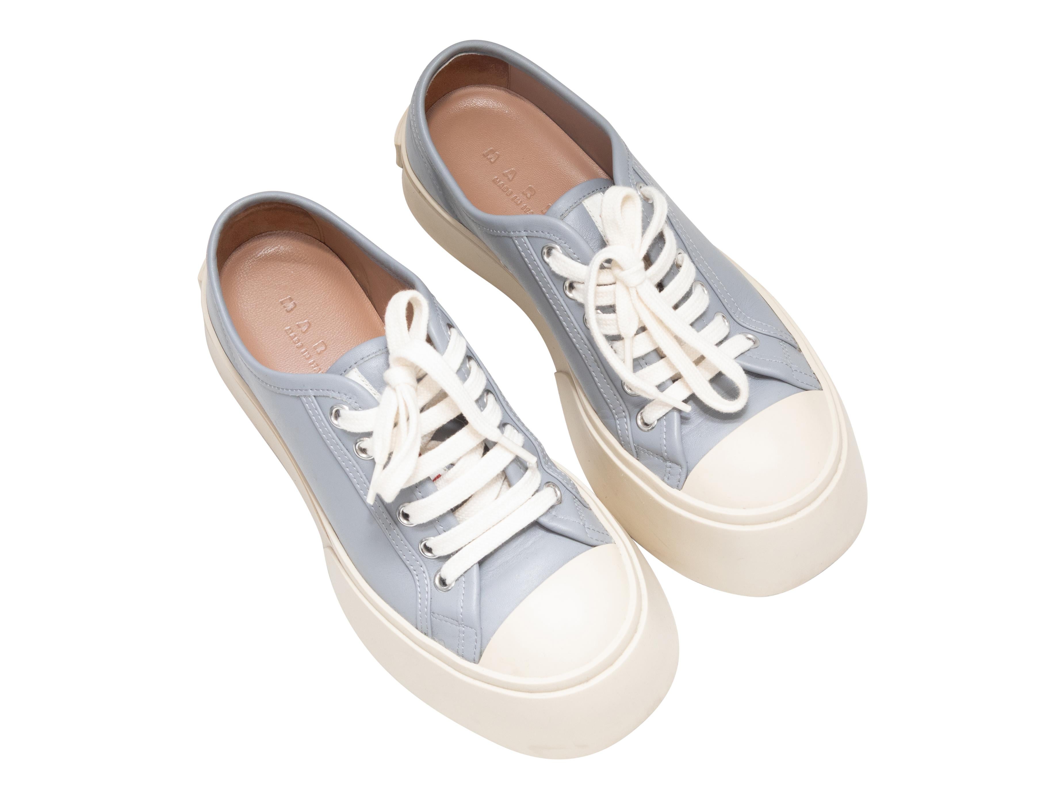 Light blue leather low-top platform Pablo sneakers by Marni. Rubber soles. Lace-up tie closures at tops. 1.75