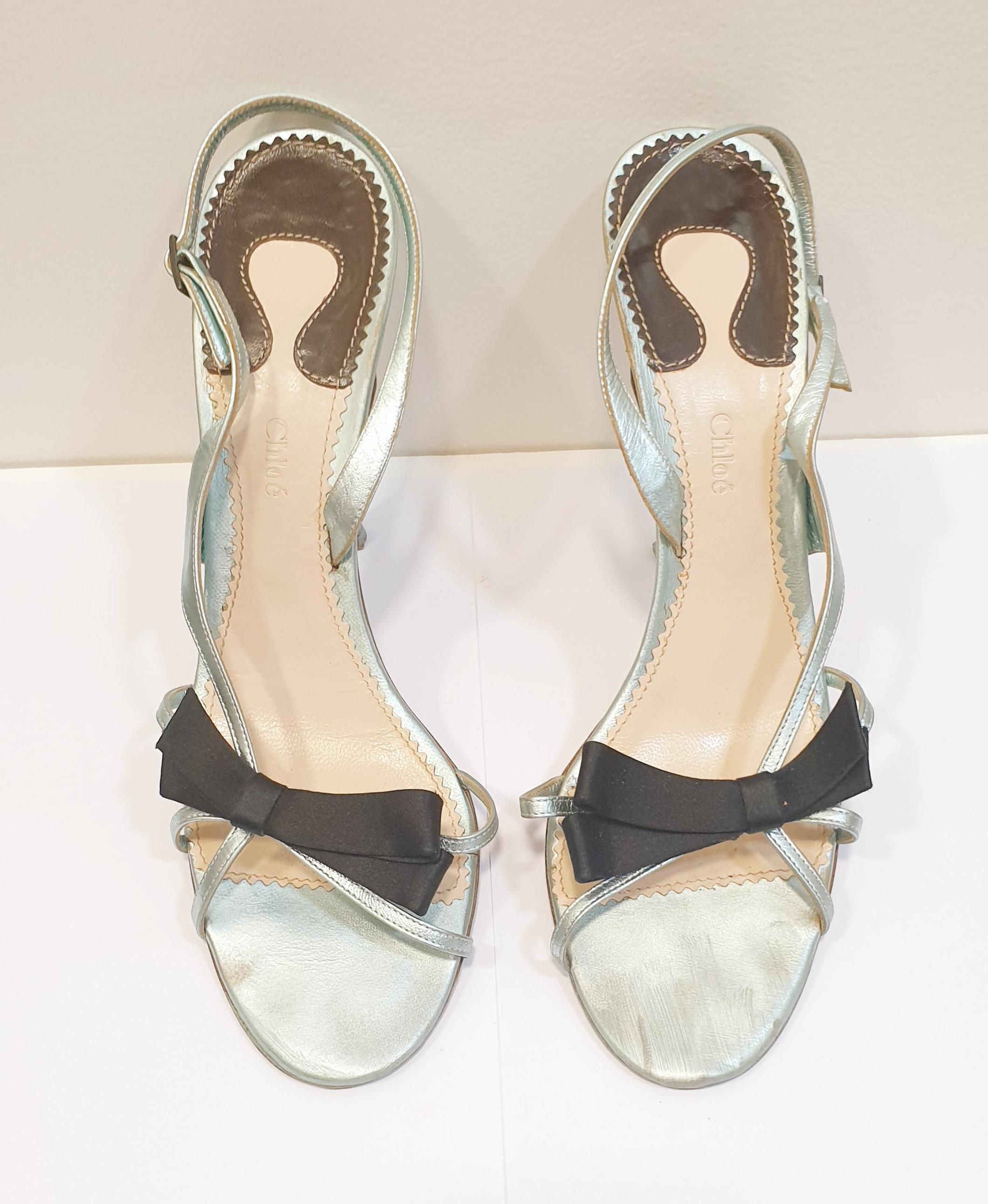 Light Metallic blue heeled sandals with Black silk lace  buckle fastening
These ultra feminine night sandal is perfect for striking an elegant pose. 
Very good previously owned condition with some light wear to leather and lined interior. 
Overall
