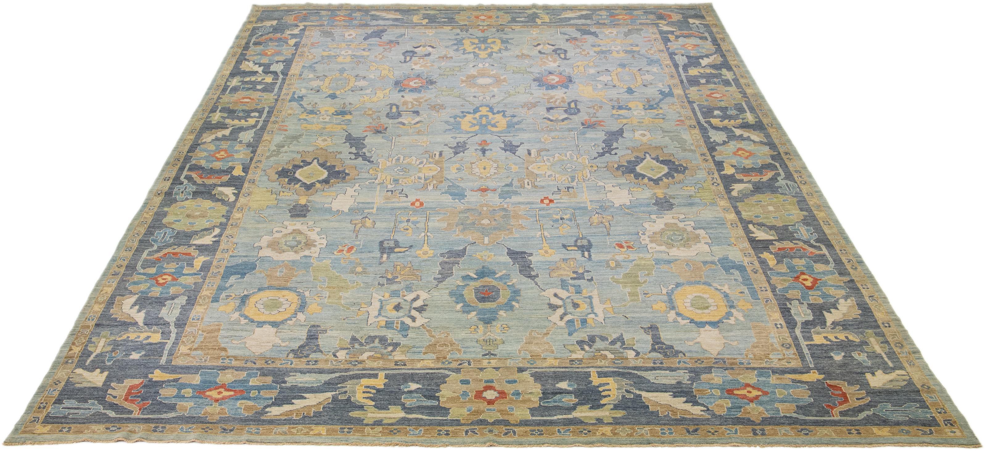This modern reinterpretation of timeless Sultanabad design is beautifully manifested in an exquisitely hand-knotted wool rug, resplendent in its striking light blue shade. An intricate navy blue border delineates its all-over floral embroidery,