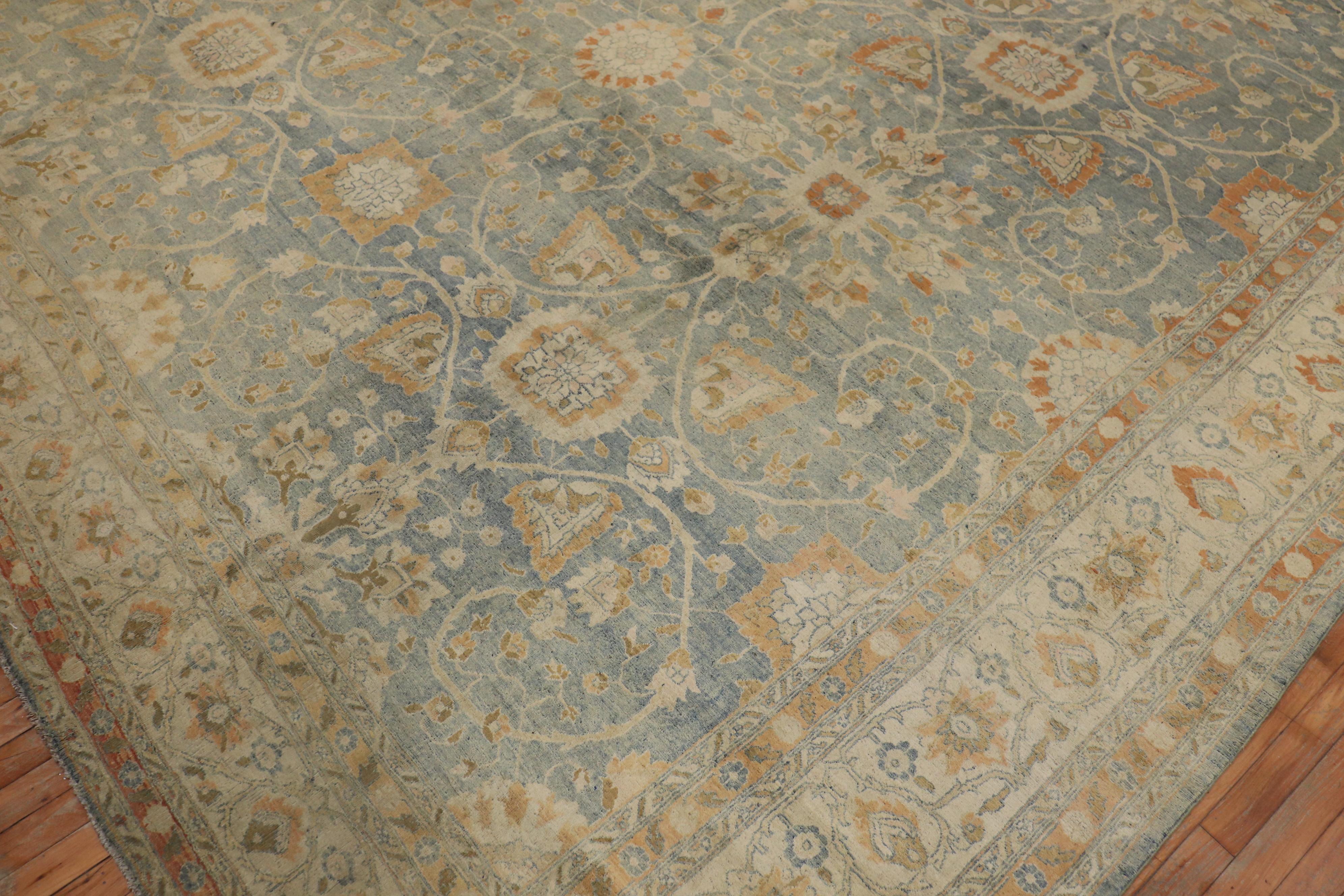 An all-over design traditional Persian Tabriz rug with a light blue field with accents in ivory and peach. The rug has a very soft silk sheen to it and soft on the feet, circa 1920.

Measures: 12'2” x 18'.