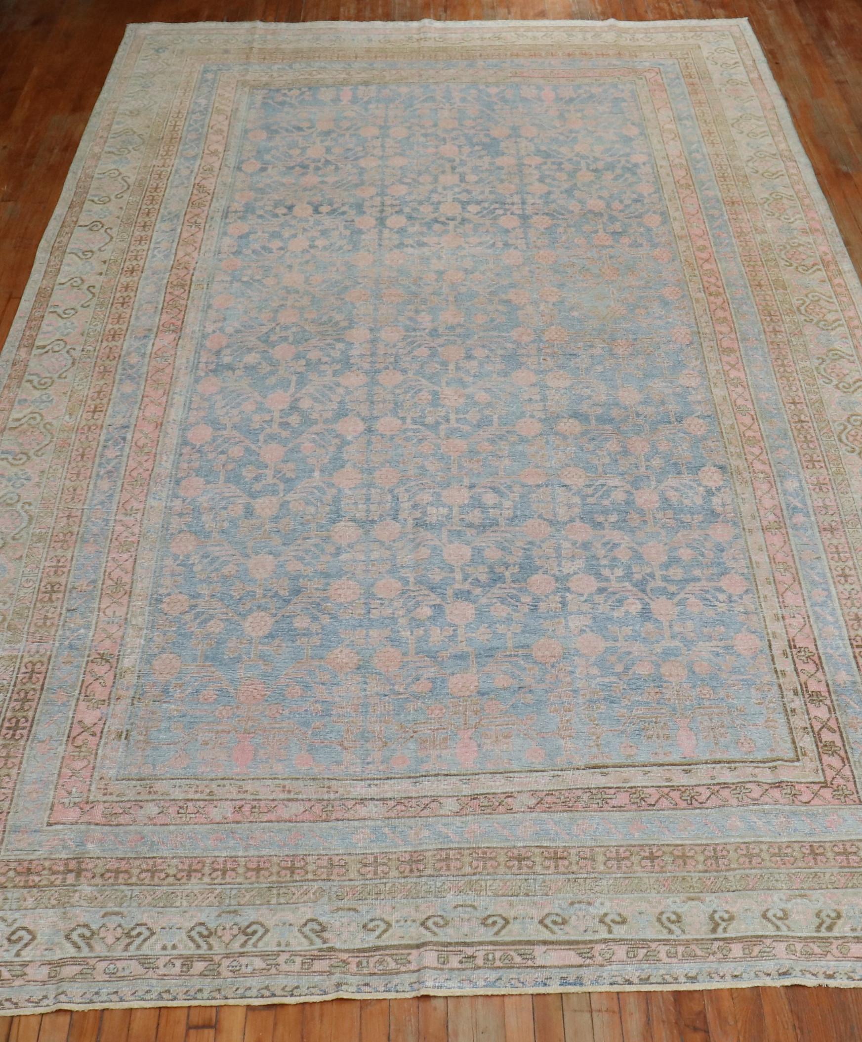 A highly decorative large antique Khotan rug from the East Turkestan Region with a light blue field, accents in pink. The pomegranate motif is infamous from this region,

circa 1910. Measures: 9'2