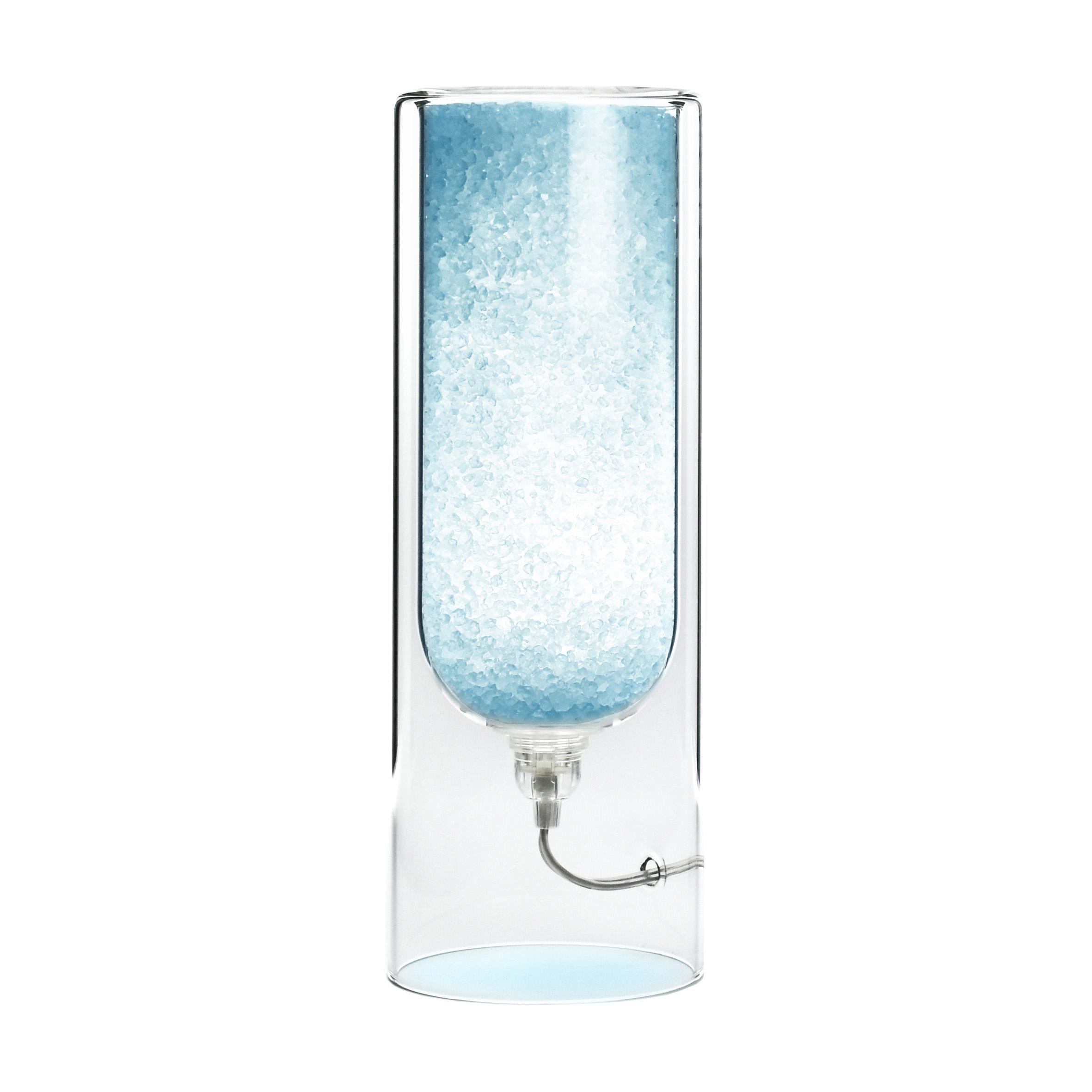 Light Blue Rocklumìna XXS table lamp by Coki Barbieri.
Dimensions: W 12 x D 12 x H 33.5 cm.
Materials: Italian rock salt crystals colored with natural pigments, mineral pigments from Italian soil and borosilicate glass.

All our lamps can be
