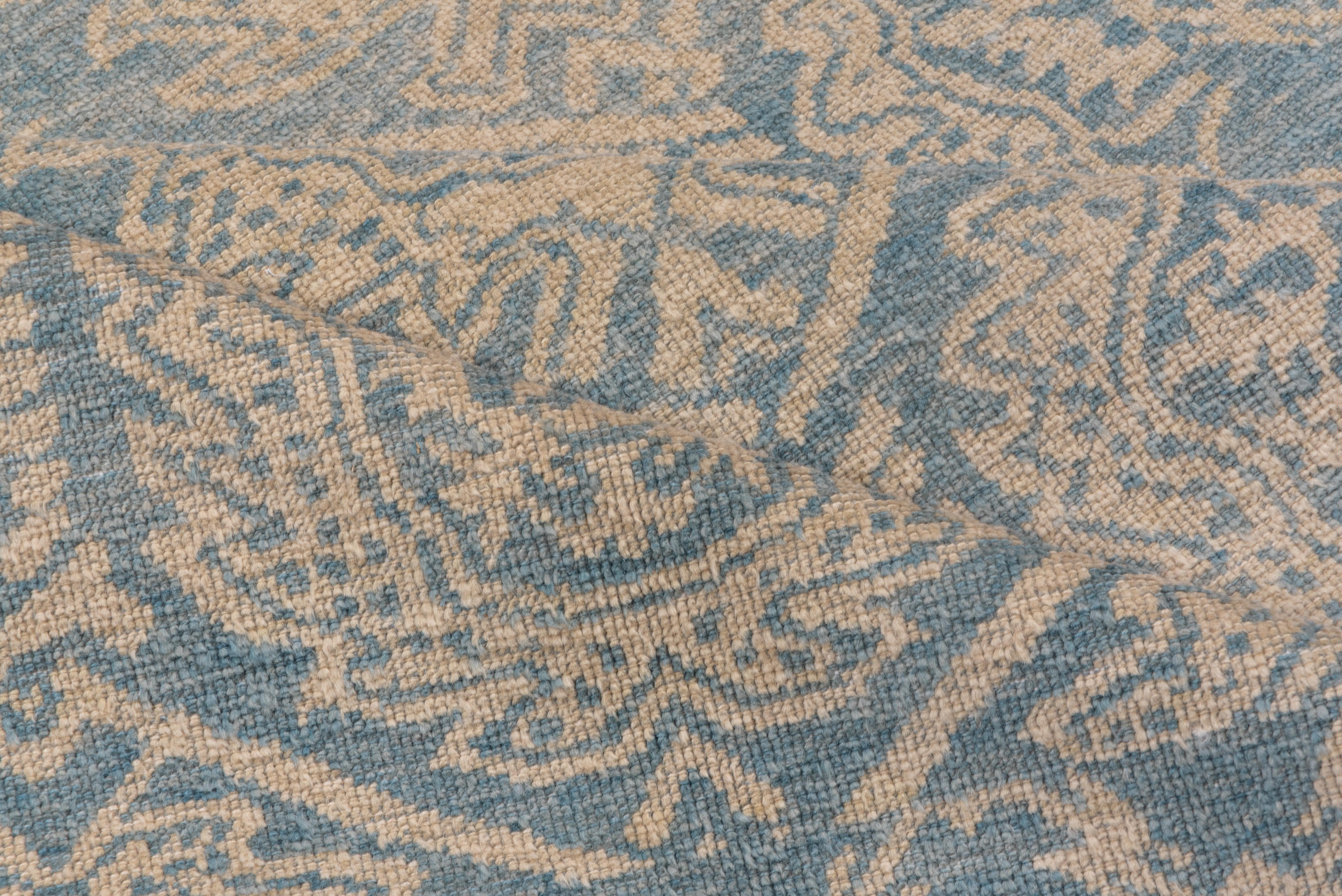 Dieser wahrscheinlich spanische Teppich aus Cuenca (um 1500) zeigt ein versetztes Kranz- und Skelettpalmetten-Allover-Muster auf dunkelblauem Grund innerhalb eines sechseckigen Spaliers, das mit Stroh akzentuiert ist. Die passende blaue Umrandung