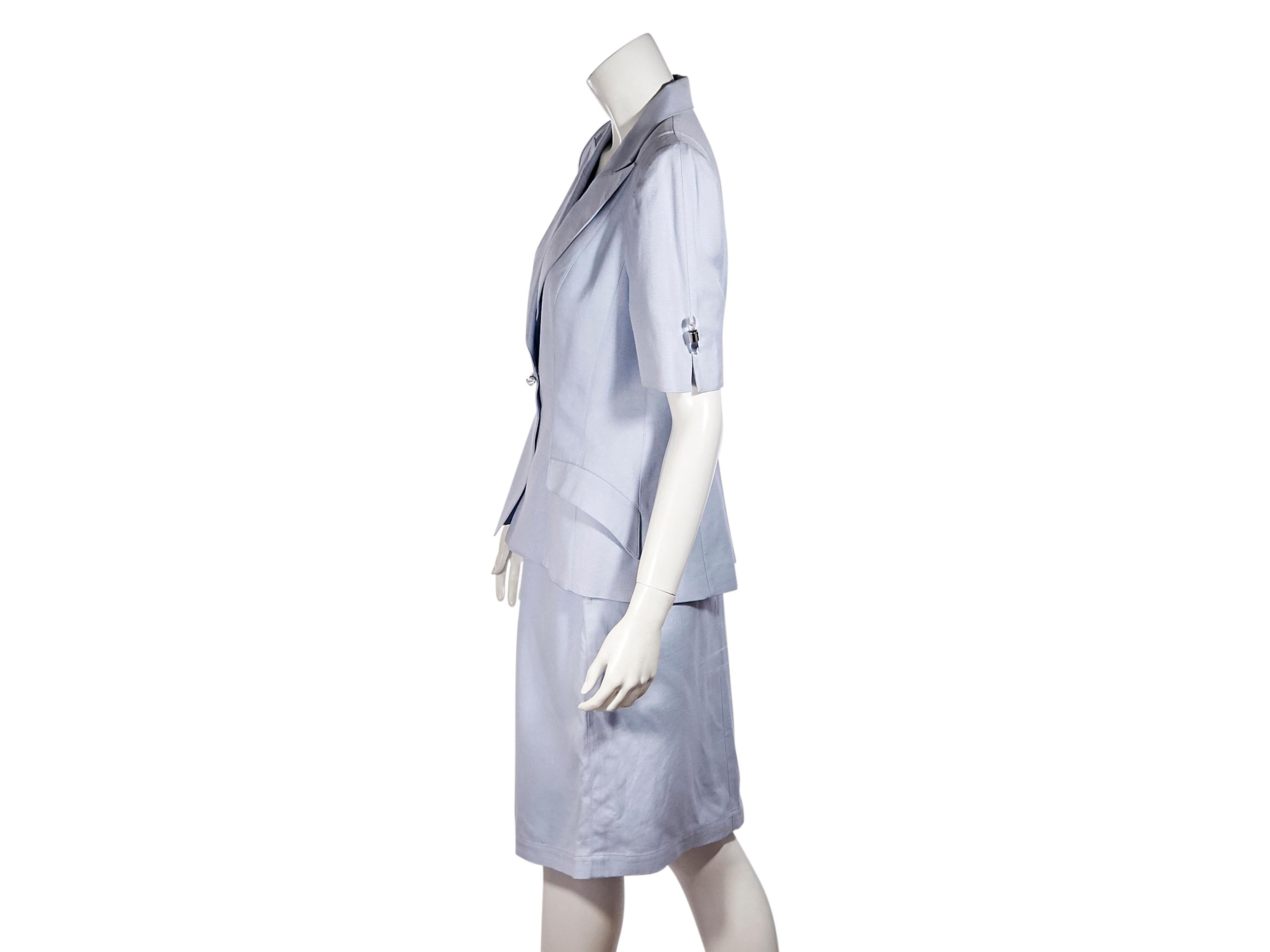 Product details:  Light blue skirt suit set by Thierry Mugler.  Peak lapel.  Elbow-length sleeves.  Single snap-front closure.  Waist flap pockets.  Matching skirt.  Banded waist.  Front hem slit.  Concealed zip and snap closure.  Label size FR 44. 