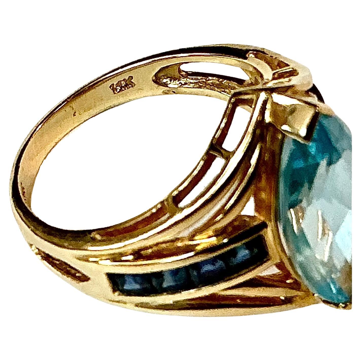 Oval Cut Light Blue Topaz with Dark Blue Topaz Baguettes 14K Yellow Gold Ring For Sale