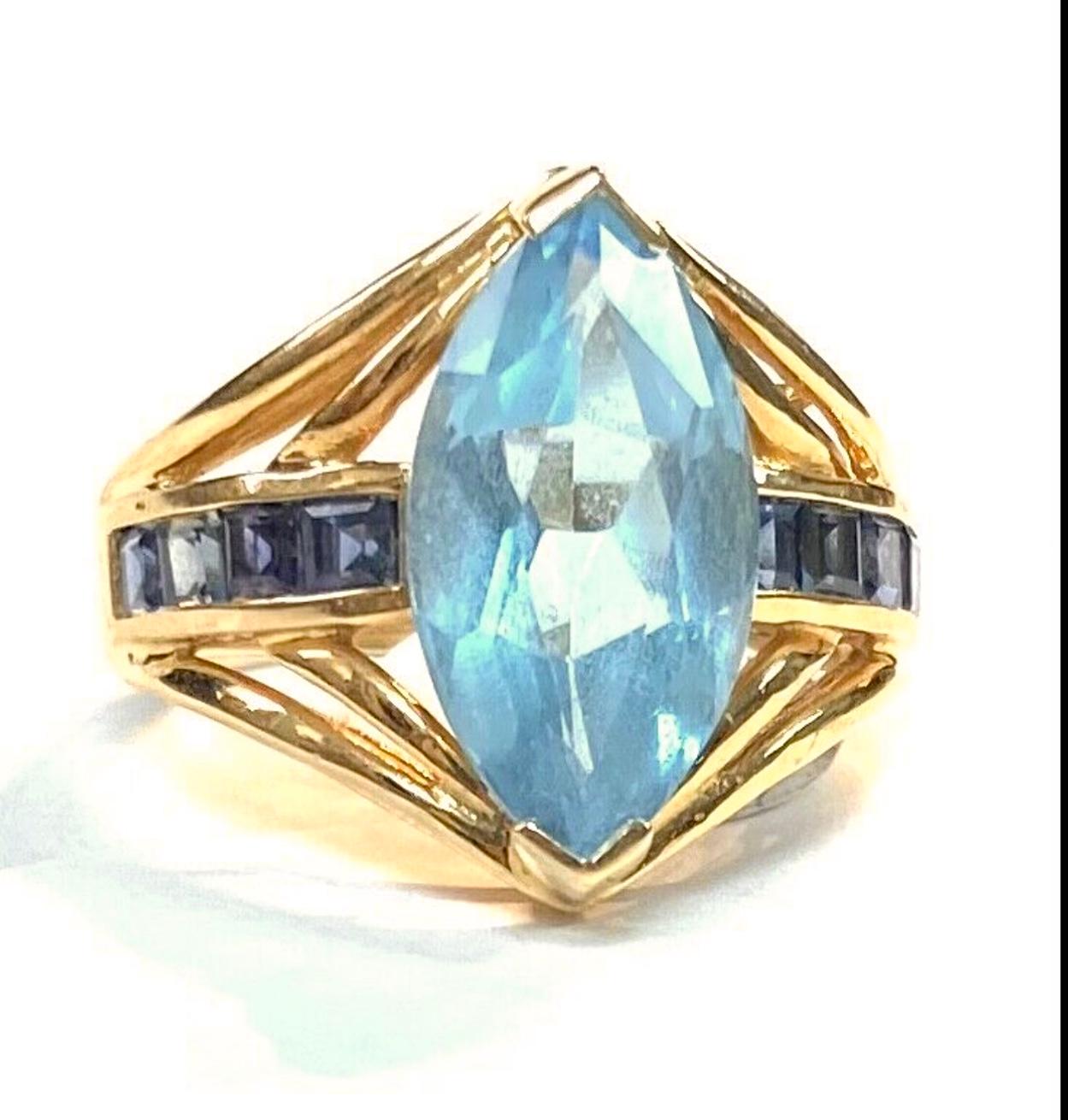 Oval Cut Light Blue Topaz with Dark Blue Topaz Baguettes 14K Yellow Gold Ring For Sale