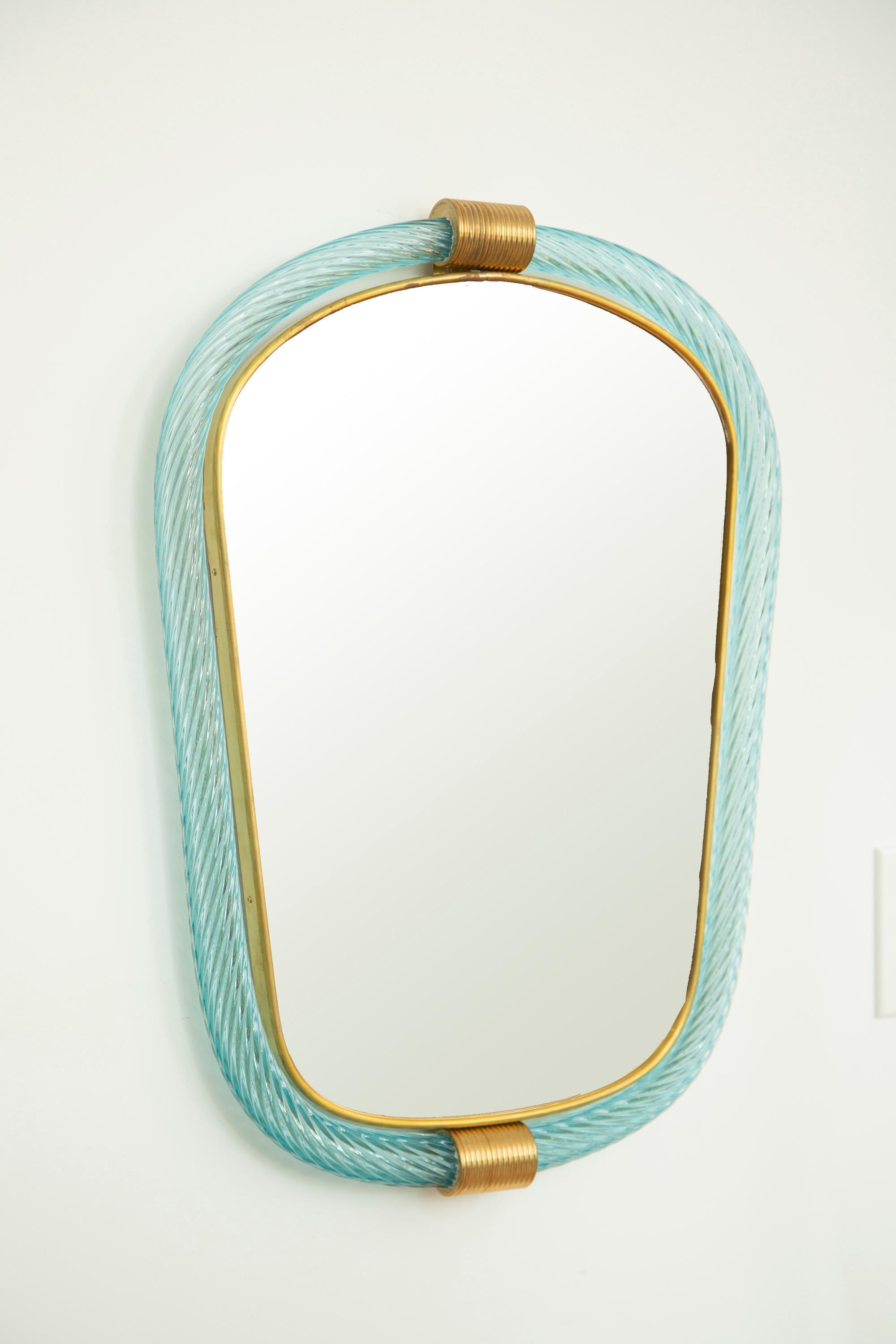 Light blue twisted rope Murano glass mirror, in stock
Two brass accents and a thin inner brass gallery
Measure: 11