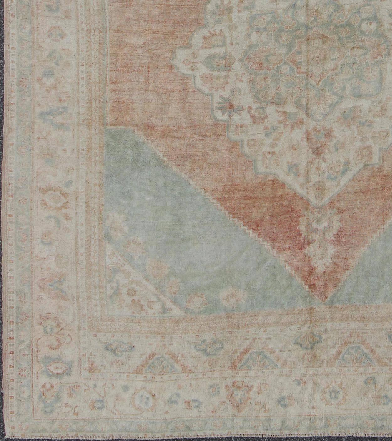 Light blue, topaz, faded grey and rust vintage Turkish Oushak rug in squared shape with layered Medallion, rug en-4093, country of origin / type: Turkey / Oushak, circa 1930

This striking vintage Turkish Oushak rug bears a faded grey-colored body
