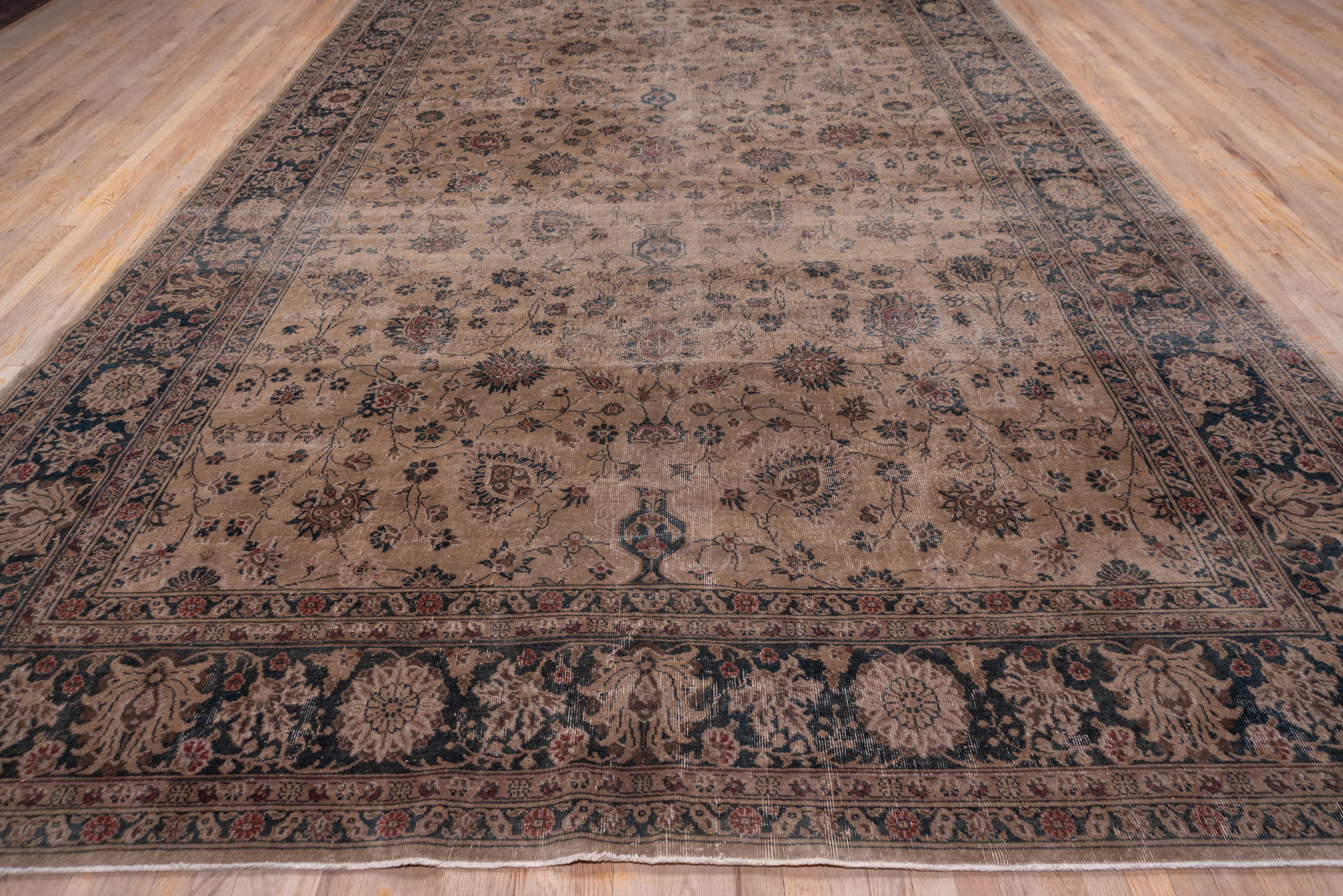 The light brown field is patterned with a Persianate all-over palmette, vase and stem pattern. The style continues into the red-brown border of long-petal palmettes and corner rosettes.