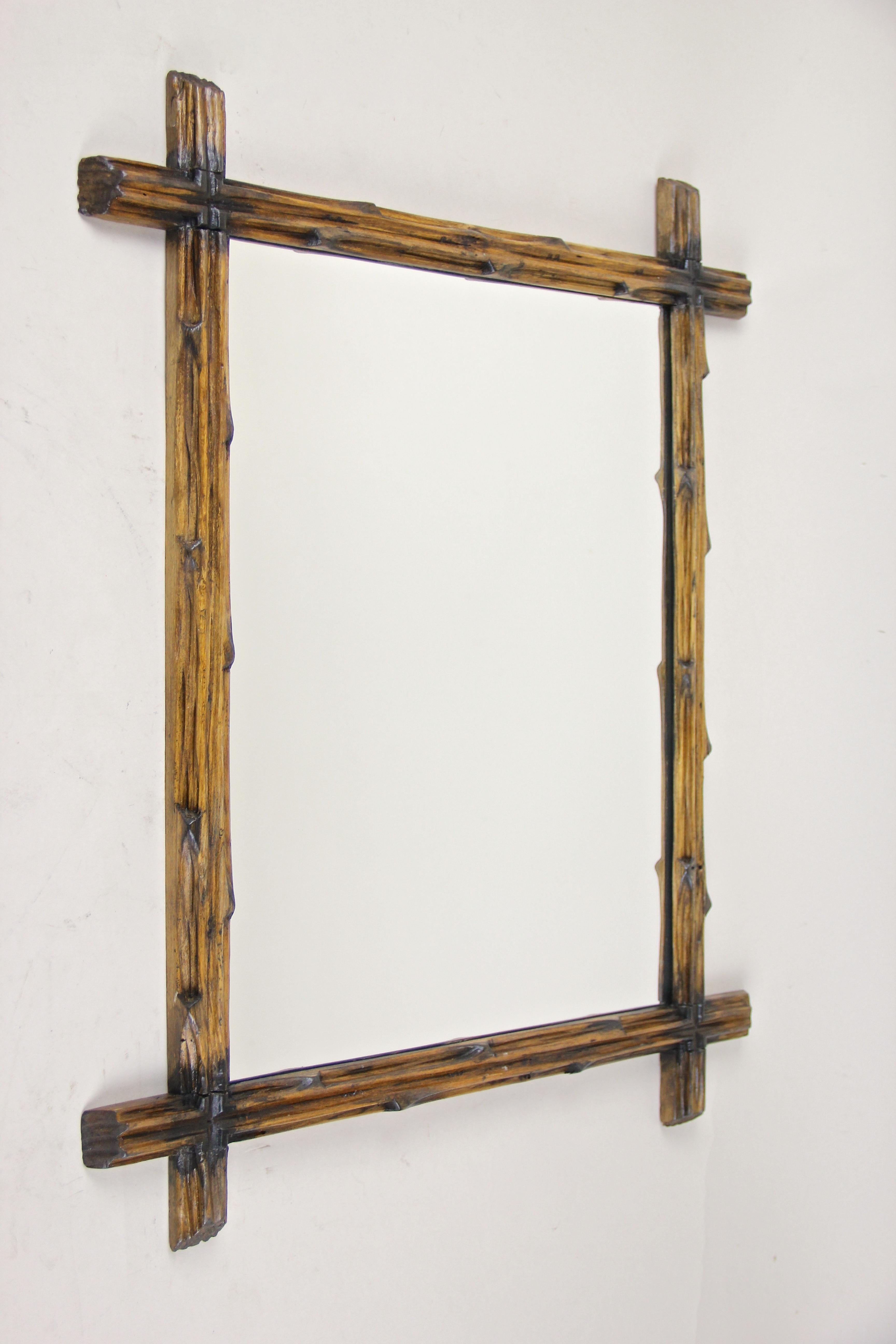 Unusual Rustic Black Forest wall mirror out of Austria. From circa 1890 comes this lovely hand carved black forest wall mirror with a simple but elegant design, created out of basswood and showing the typical 