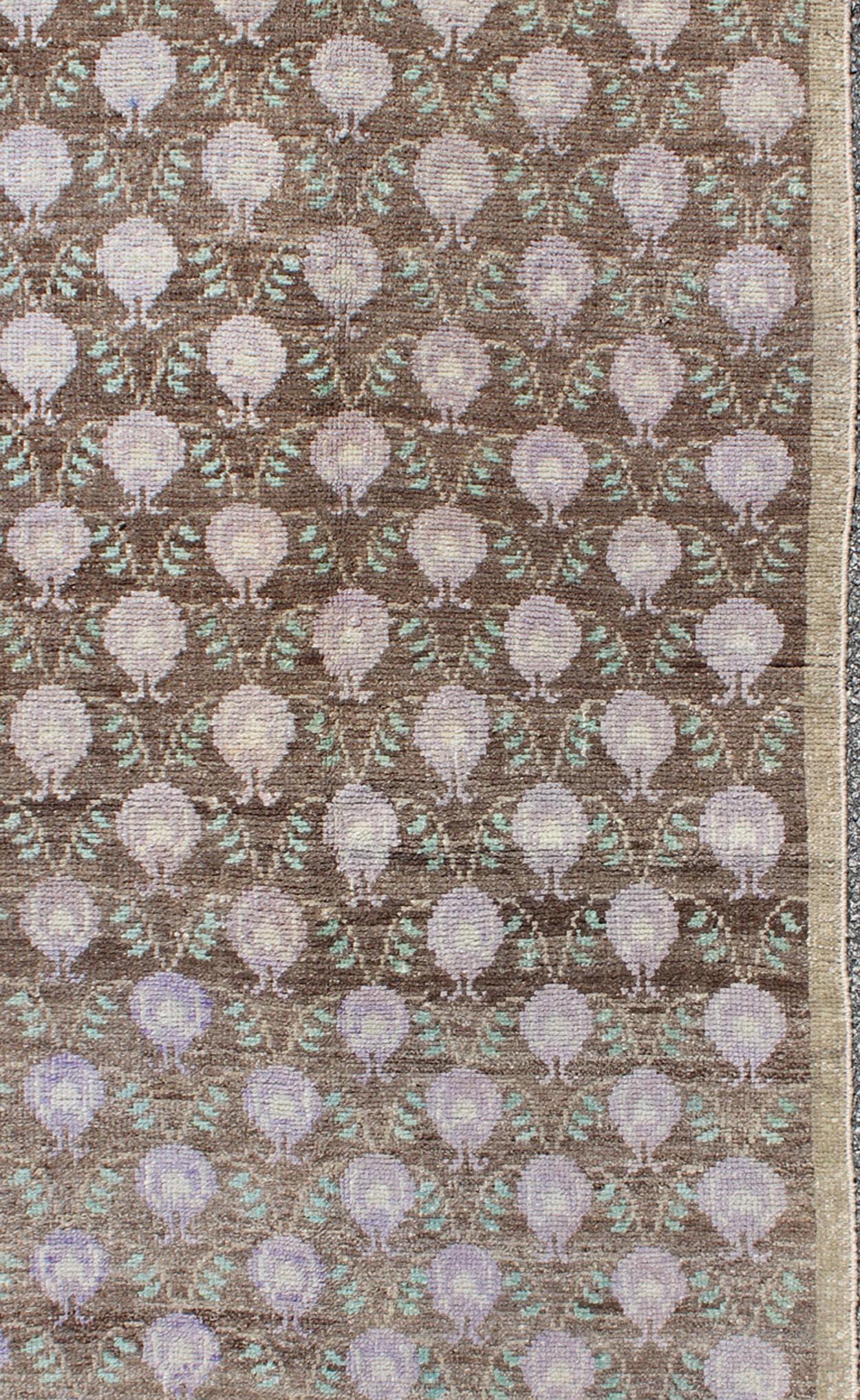 This vintage Turkish Tulu carpet (circa mid-20th century) features an all-over pattern of vining latticework flanked by cream half-moon shapes. Colors include taupe, brown, green, and lavender. These marvelous combinations make this rug suited for a