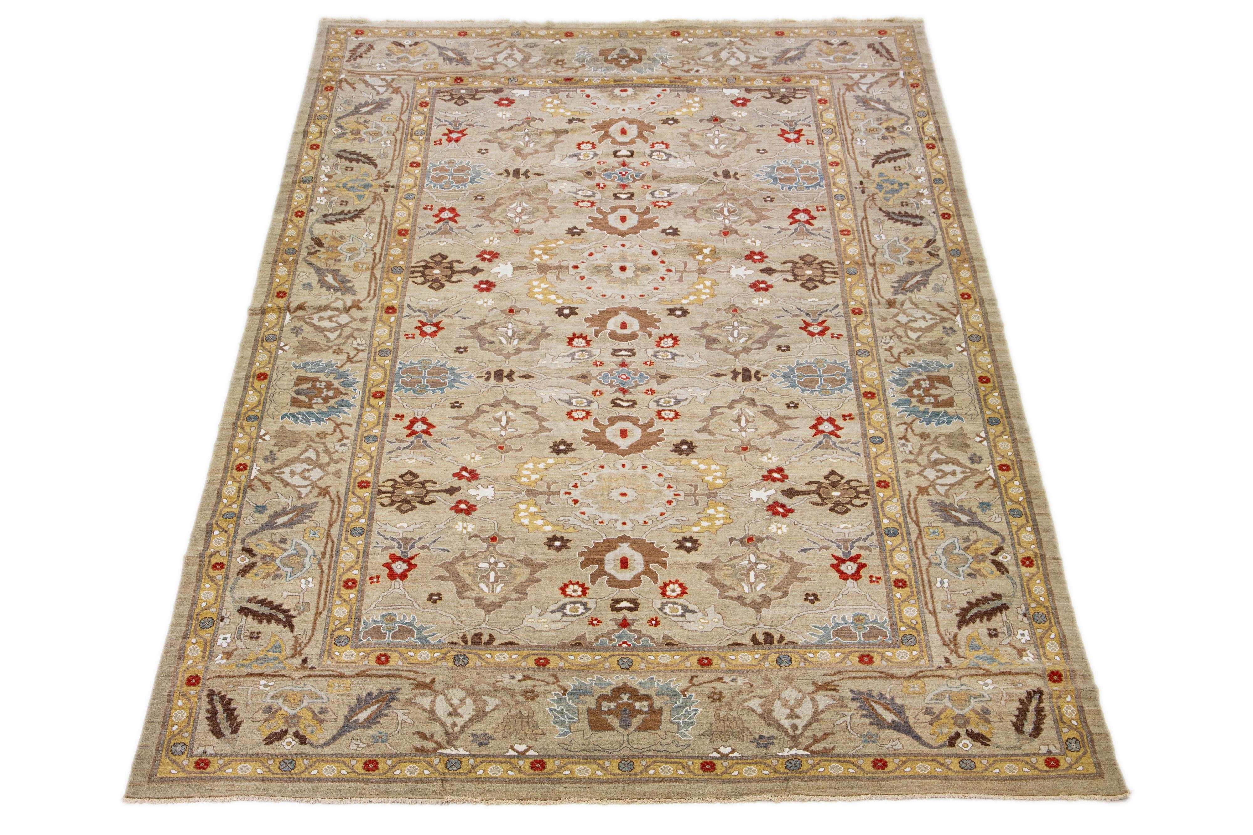 An elegant, oversized Sultanabad wool rug in a contemporary style is available. It features a light brown base color with a variety of multicolored accents. The rug is visually enriched with an expansive floral pattern.

This rug measures: 12'3
