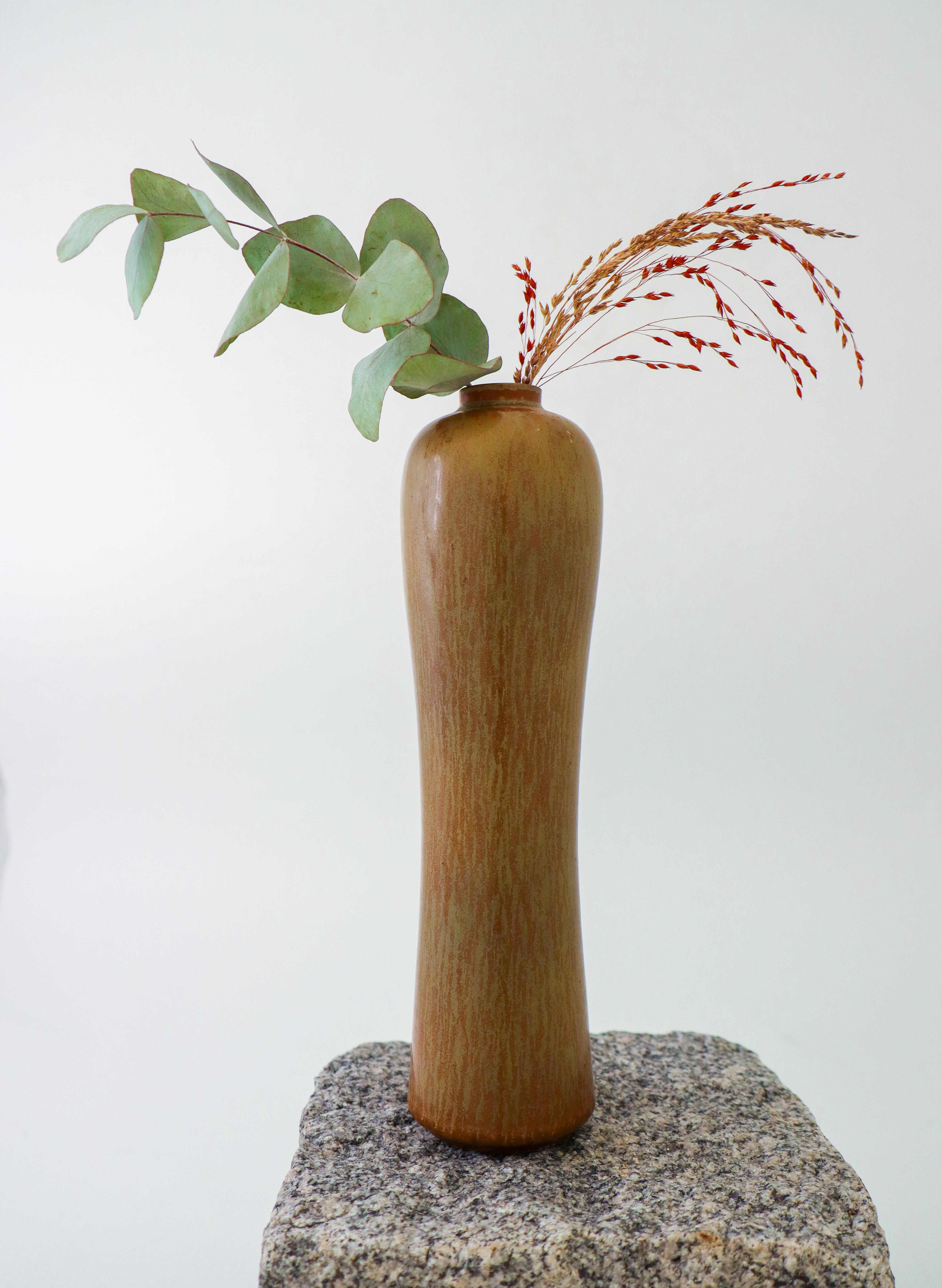 A light brown, high ceramic vase designed by Gunnar Nylund at Rörstrand. It is 24 cm (9.6