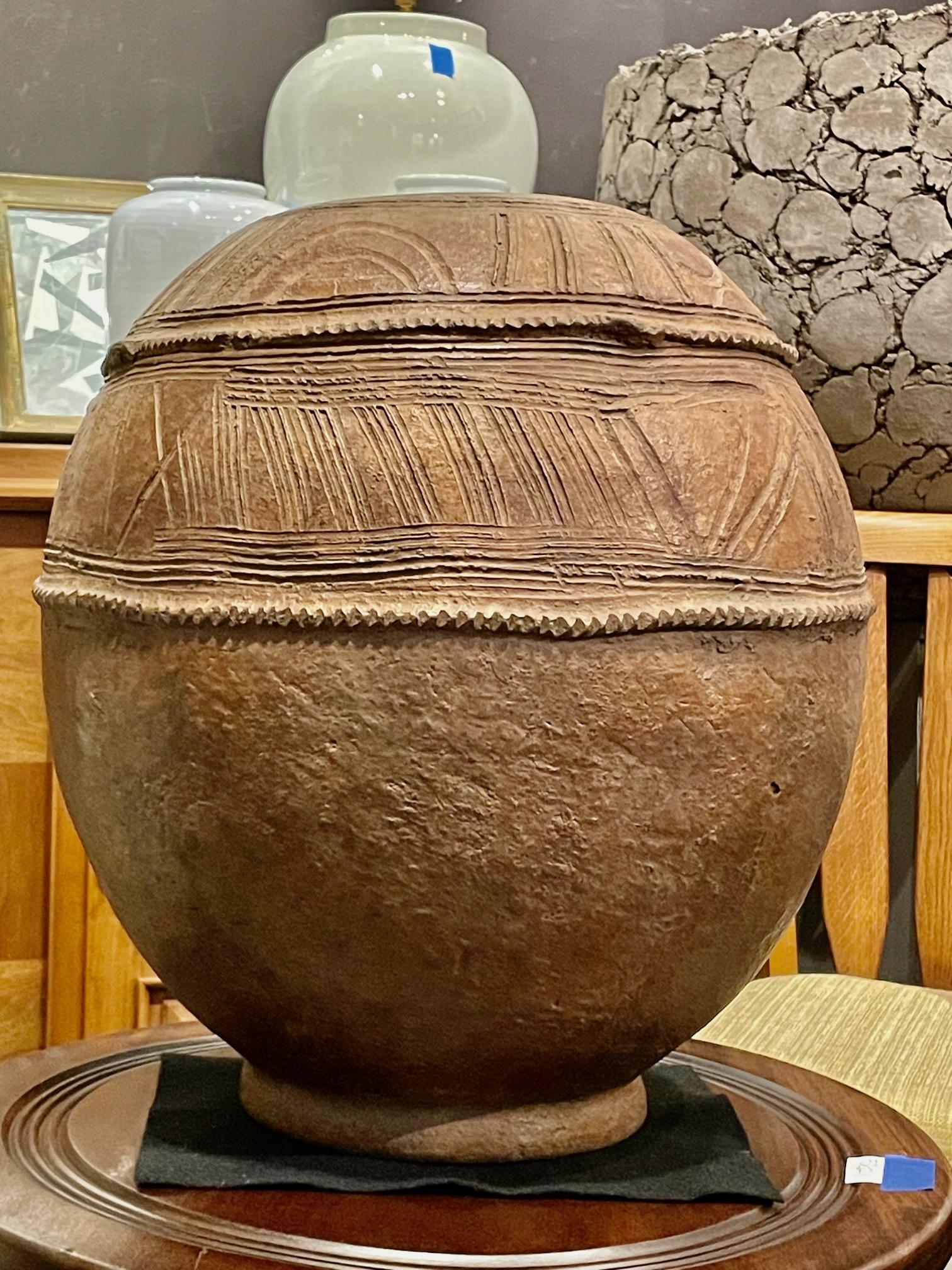 1950s Ethiopian light brown terracotta large water vessel with decorative design.
Patterned band of textured design framed by two rows of carved ribs.
Several available each having its' own distinct textured design.