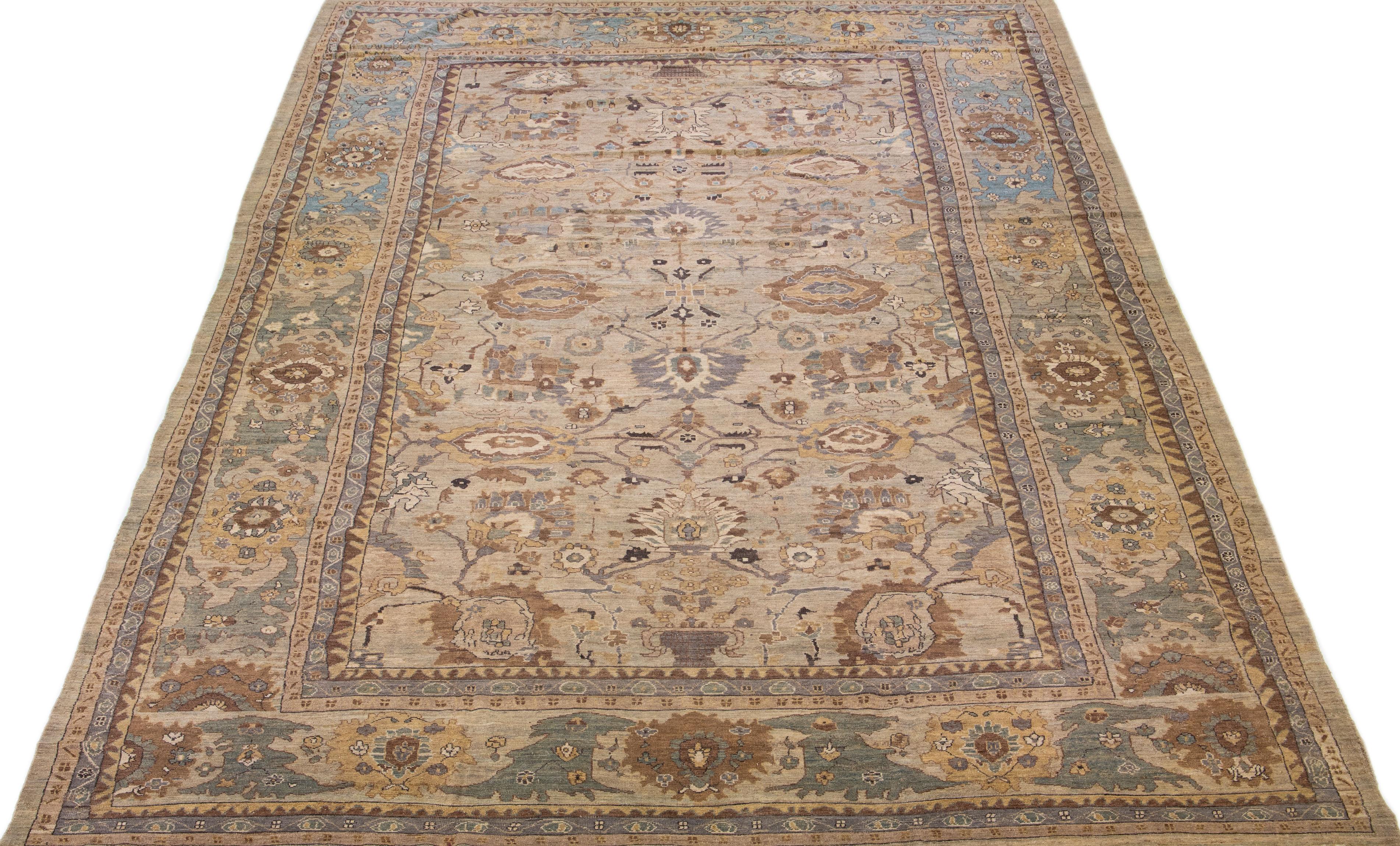 Beautiful modern Sultanabad hand-knotted wool rug with a brown color field. This rug has a designed frame with yellow, blue, and pink accents in a gorgeous all-over floral design.

This rug measures: 13'5