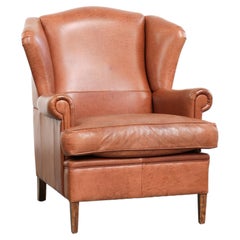 Light cognac-coloured English wingback armchair made of cowhide leather