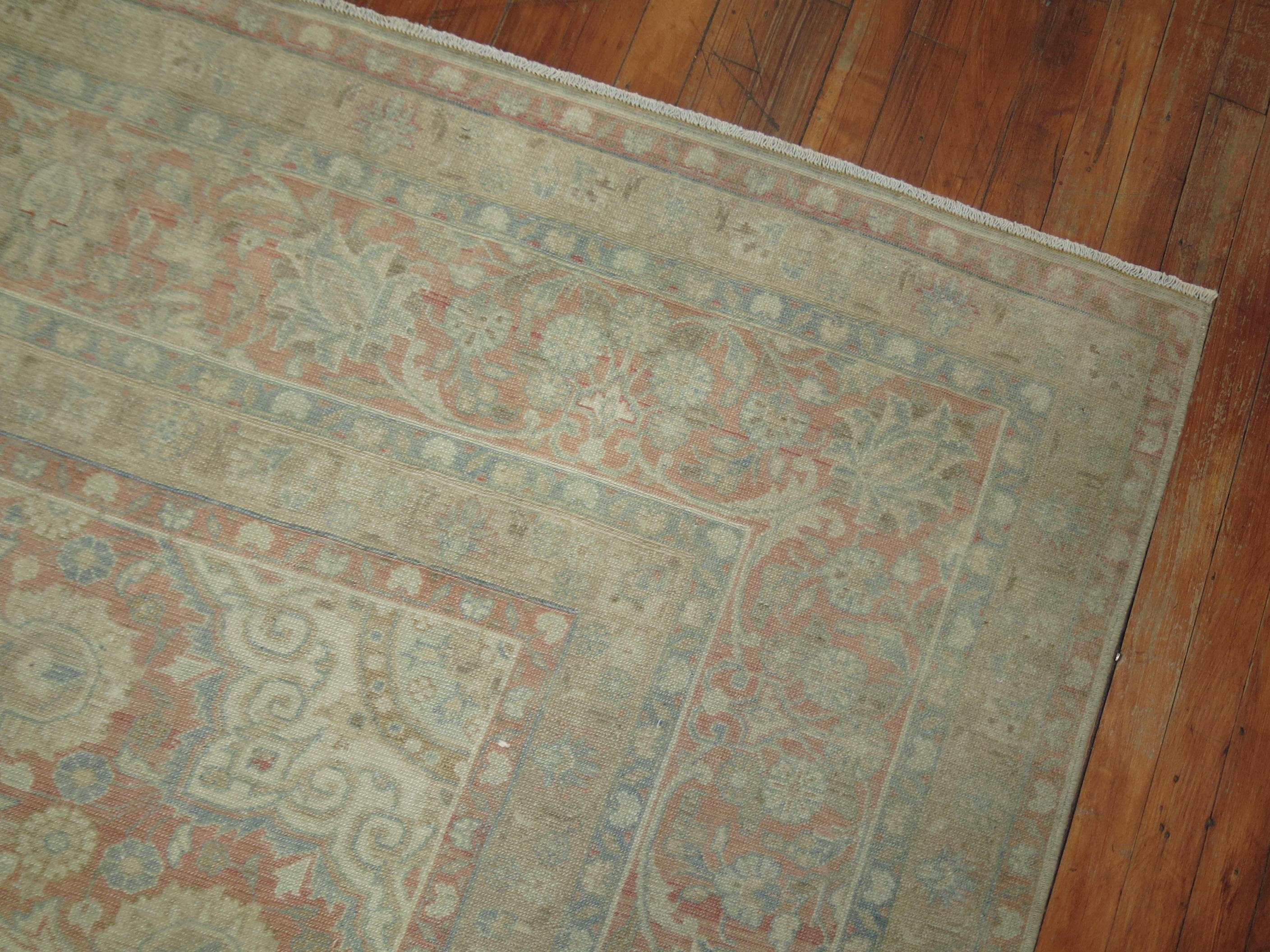 A room-size antique Persian Tabriz rug woven, early 20th century. Classic, Elegant, and the quality is there. the field is a light blue, small ivory medallion in the center of the field, accents in light brown, rosy pink.

Measures: 9'8