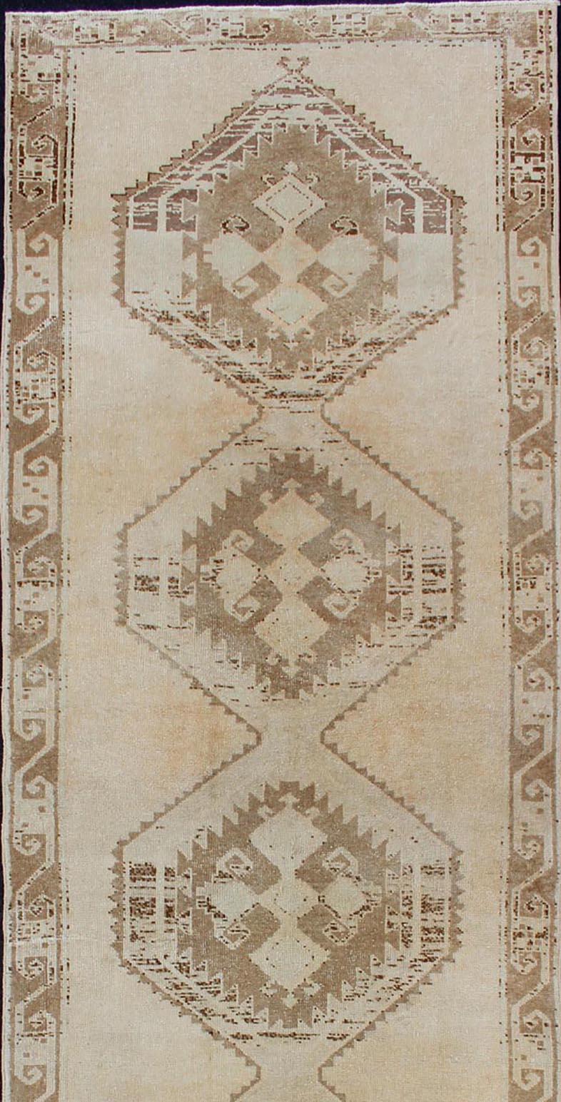 Turkish Light Colored Vintage Oushak Gallery Runner with Geometric Medallions For Sale