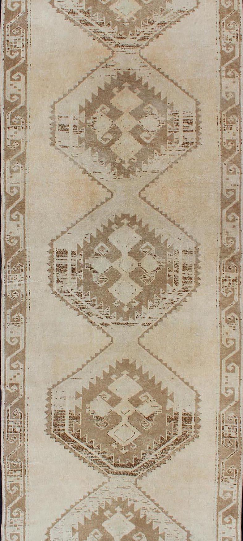 Hand-Knotted Light Colored Vintage Oushak Gallery Runner with Geometric Medallions For Sale