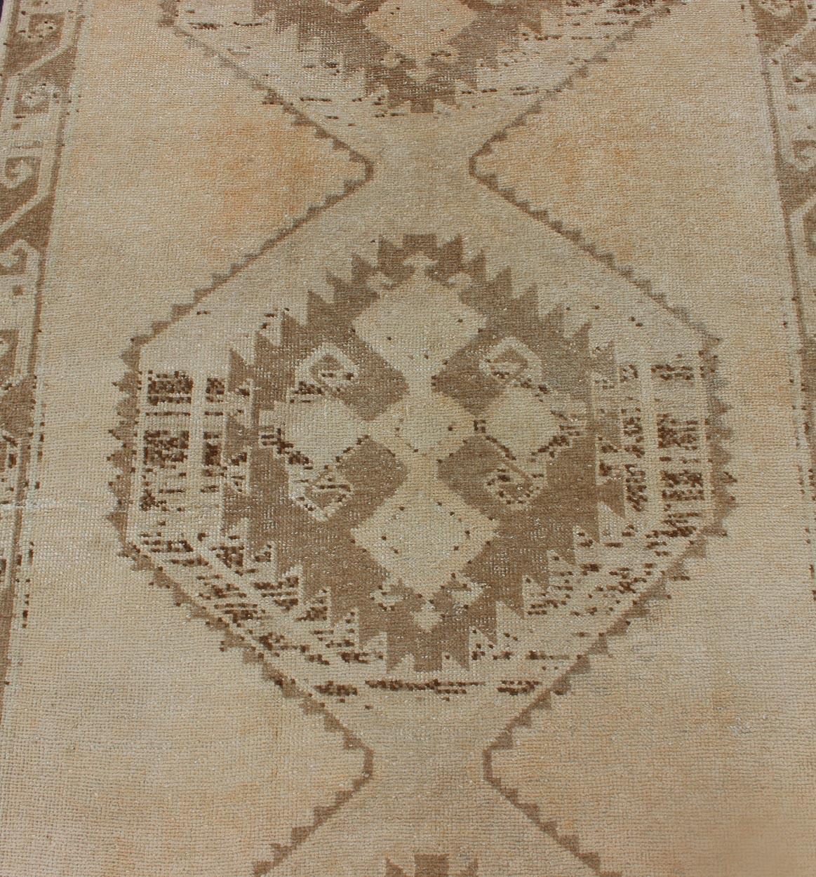 20th Century Light Colored Vintage Oushak Gallery Runner with Geometric Medallions For Sale
