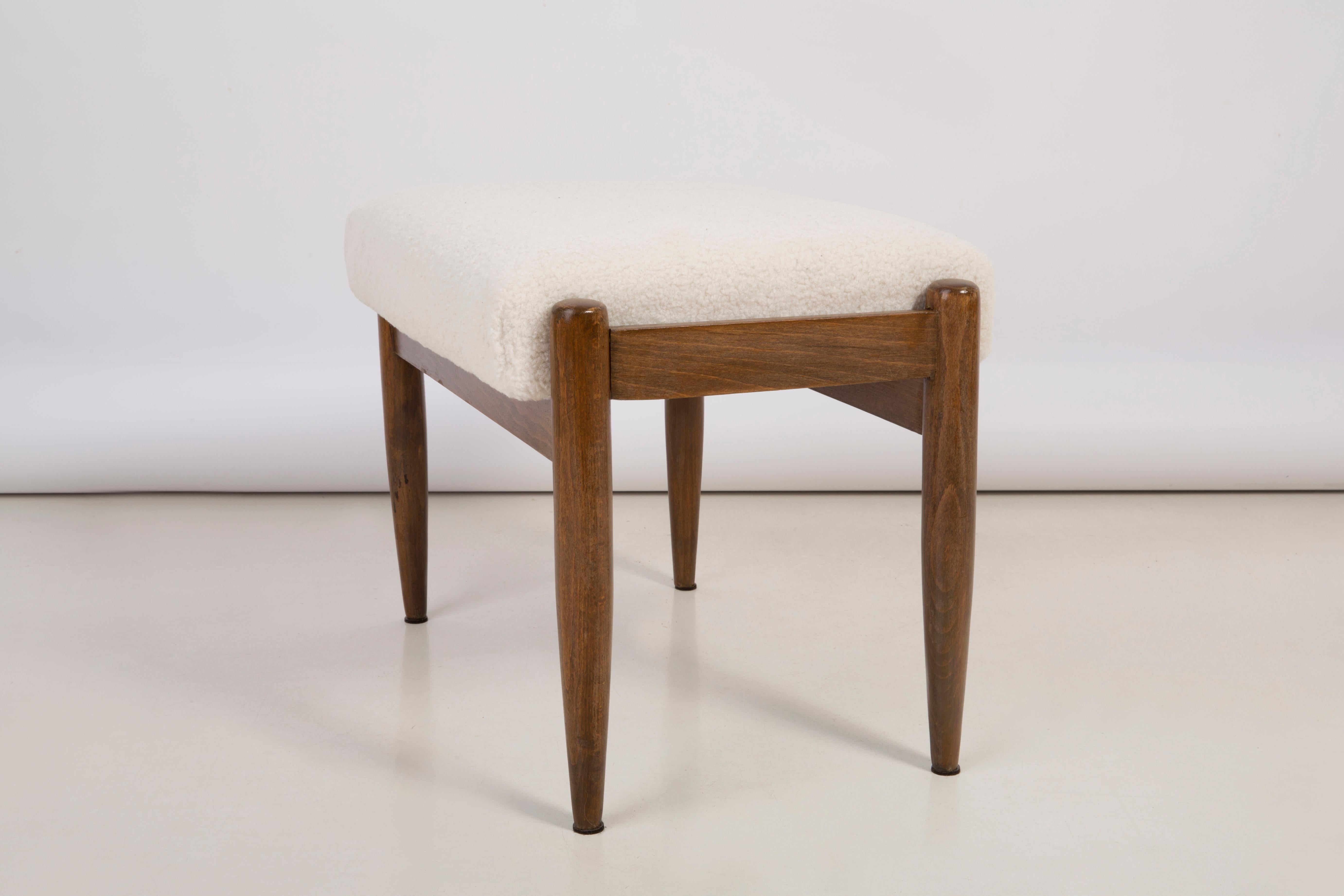 Stool from the turn of the 1960s. The stool consists of an upholstered part, a seat and wooden legs narrowing downwards, characteristic of the 1960s style. 

Stool was designed by Edmund Homa, a Polish architect, designer of industrial design and