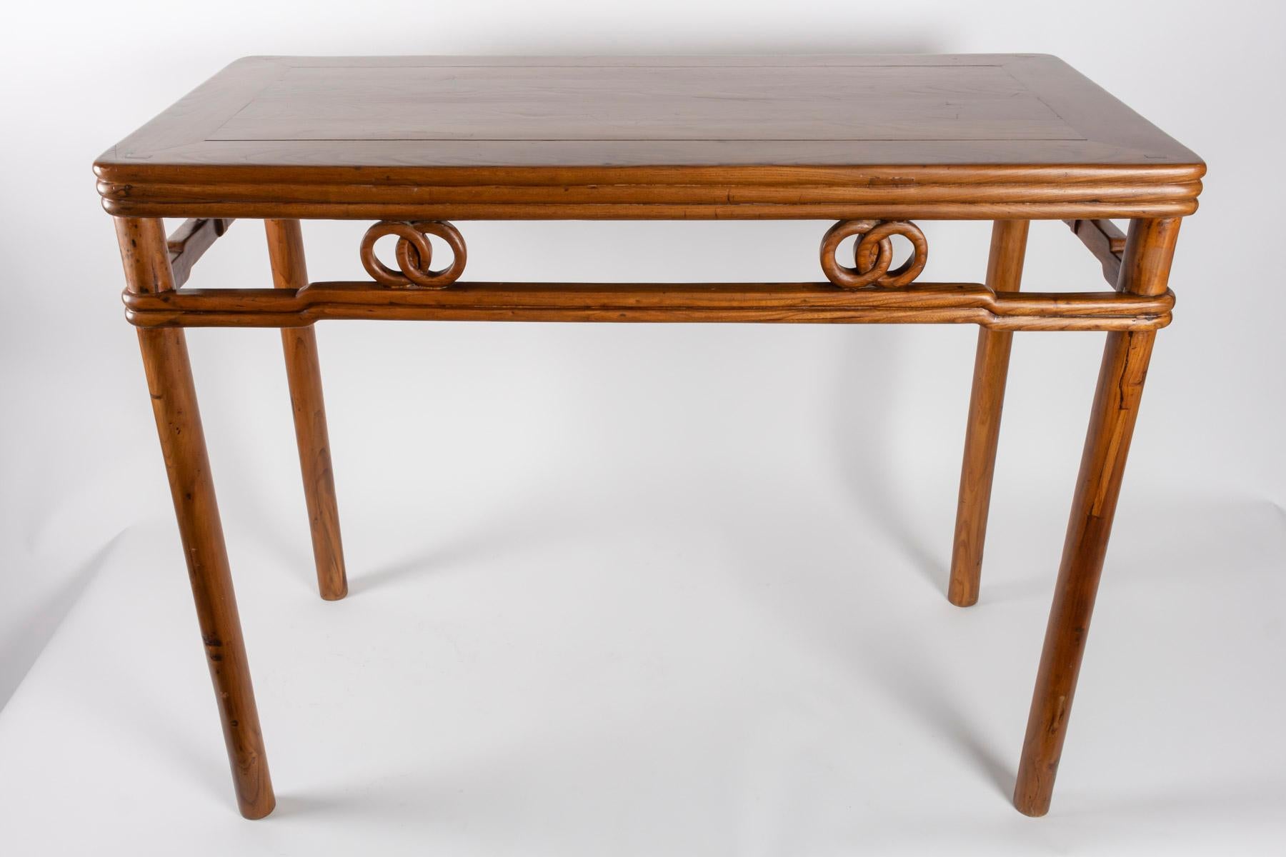 Light fruitwood table with rings decor on belt, China, 1900
Measures: H: 84cm, W: 52cm, W: 106cm.